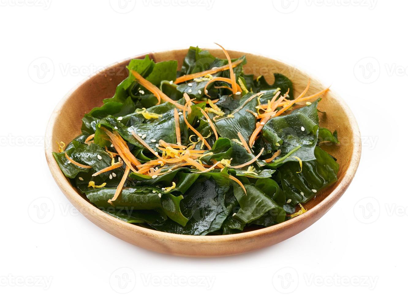 Laminaria or Kelp Seaweed salad in wood plate Isolated on White Background. fresh Laminaria or kelp Seaweed Isolated on White Background. konbu, alga photo