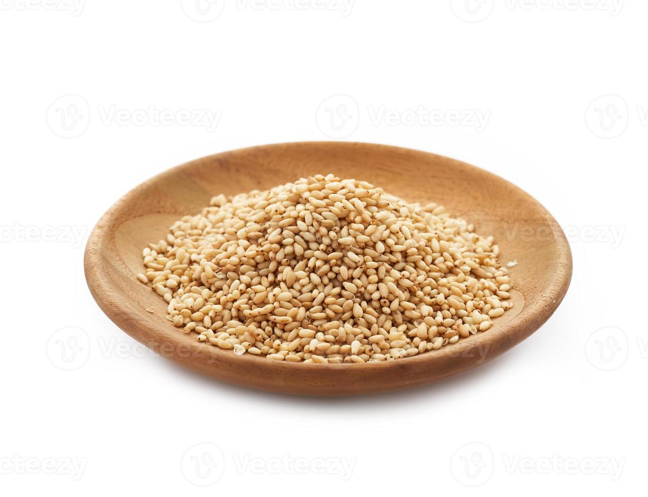 roasted sesame seed in wood plate isolated on white background. a pile of Toast sesame seed isolated on white background. roasted sesame photo