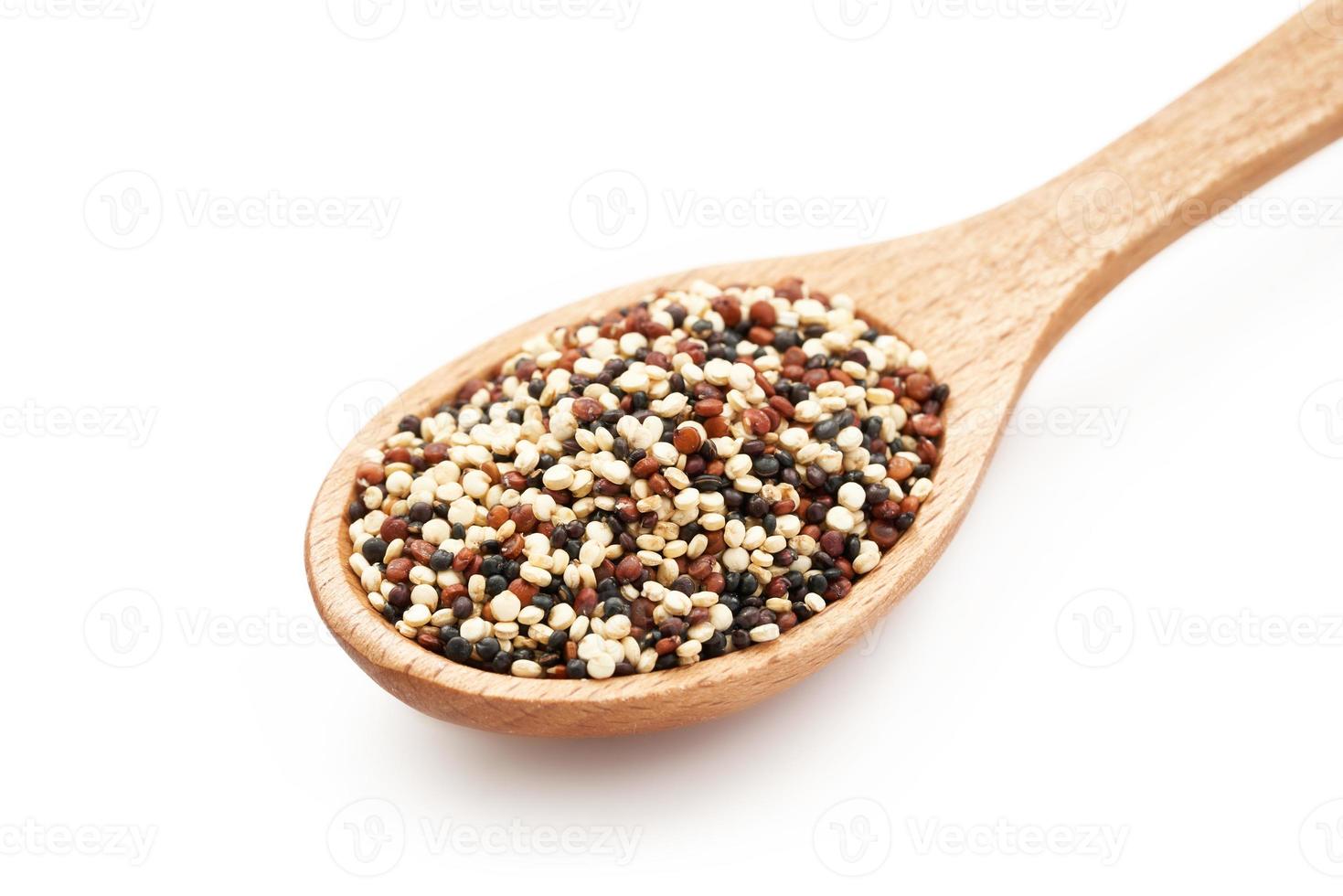 quinoa seeds in wooden spoon isolated on white background. close up quinoa seeds in wooden spoon isolated on white background. quinoa seeds in spoon isolated photo