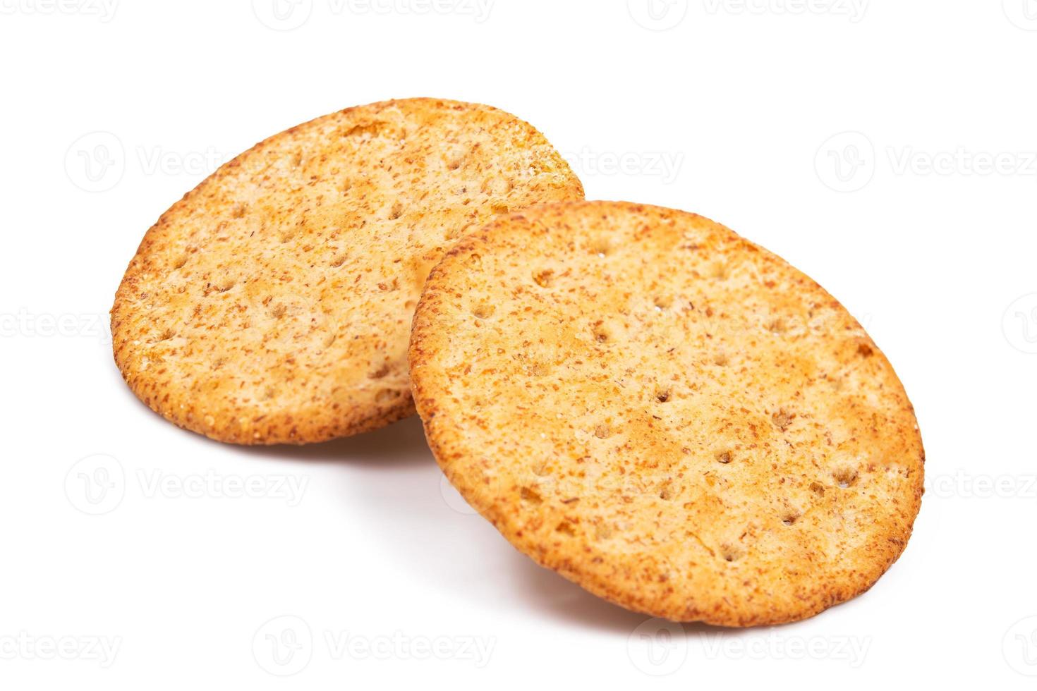 Baked round cracker chips isolated on white background. Wheat cracker chips isolated on white background. Whole wheat cracker isolated on white background with clipping path photo