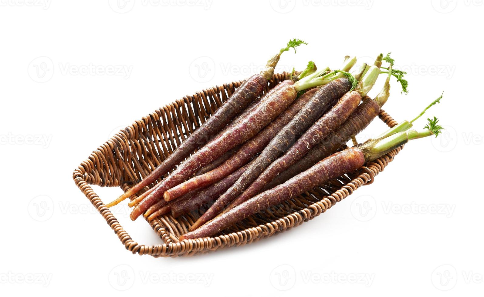 Carrot Baby Purple in wood basket isolated on white background. Carrot Baby Purple isolated. black Carrot Baby Purple isolated photo