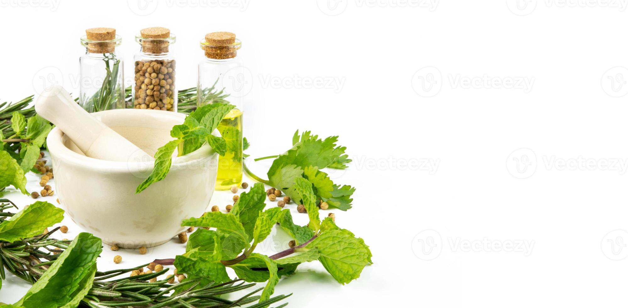 mortar with herbs on white background photo