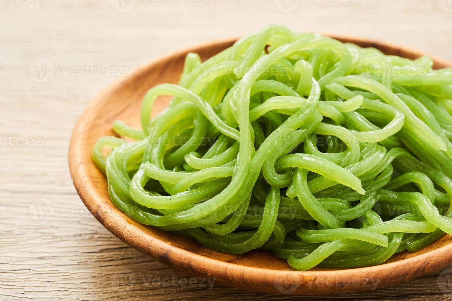 green konjac noodle in wooden plate on wood table background 22841048
