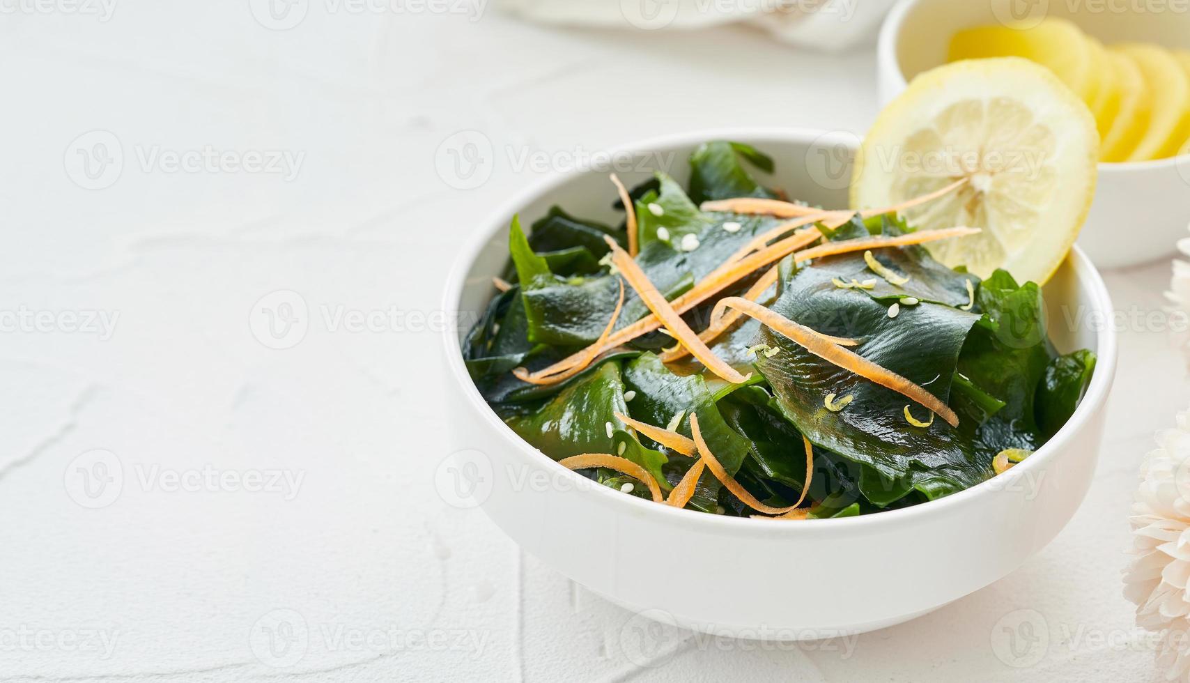 close up salad laminaria Kelp or wakame seaweed salad in bowl on white table background with copy space. salad laminaria Kelp or wakame seaweed salad food photo