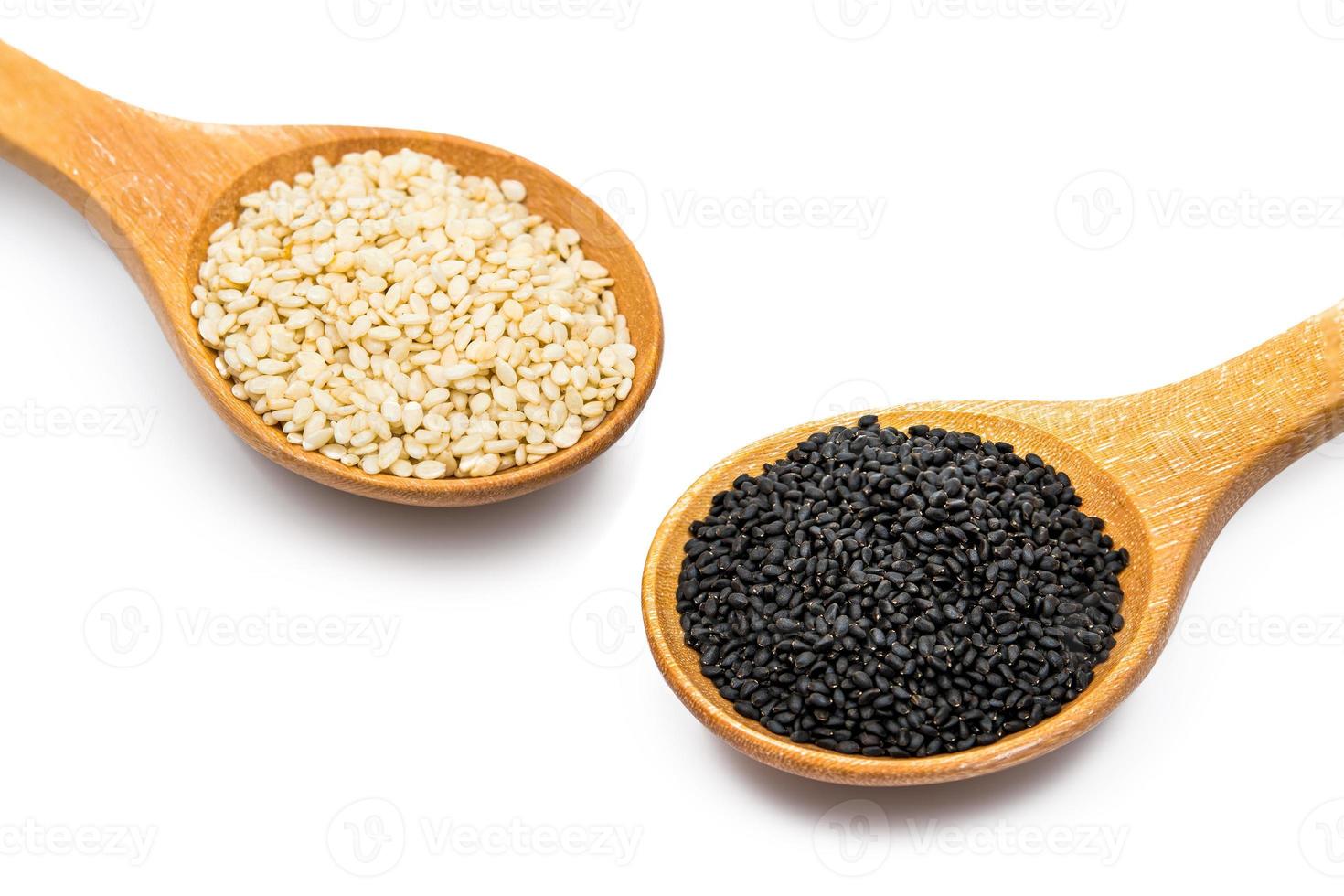 white and black sesame seeds with spoon isolated on white background photo