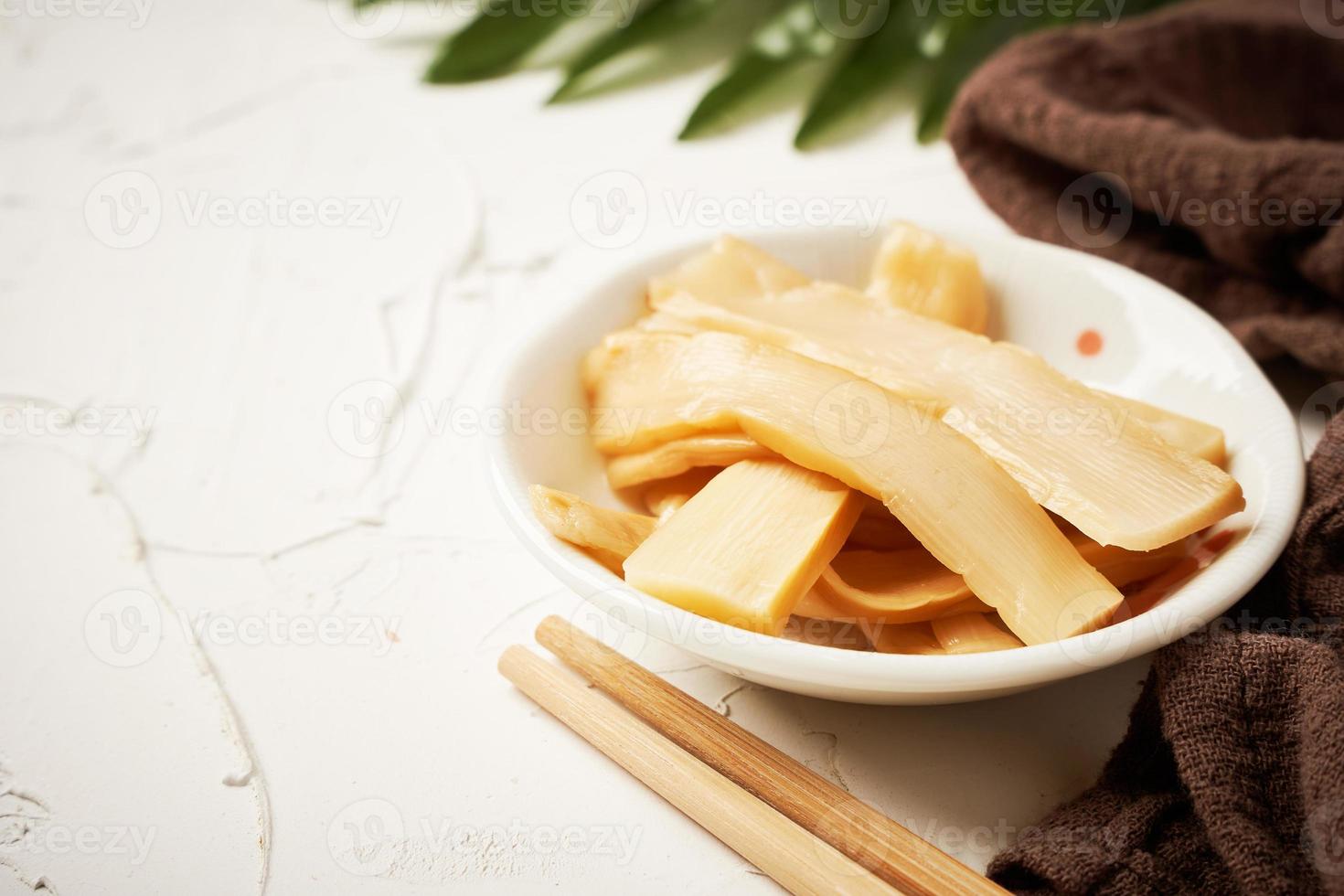 Ajitsuke Menma Pickled Bamboo Shoot in a white dish on white table background with copy space photo