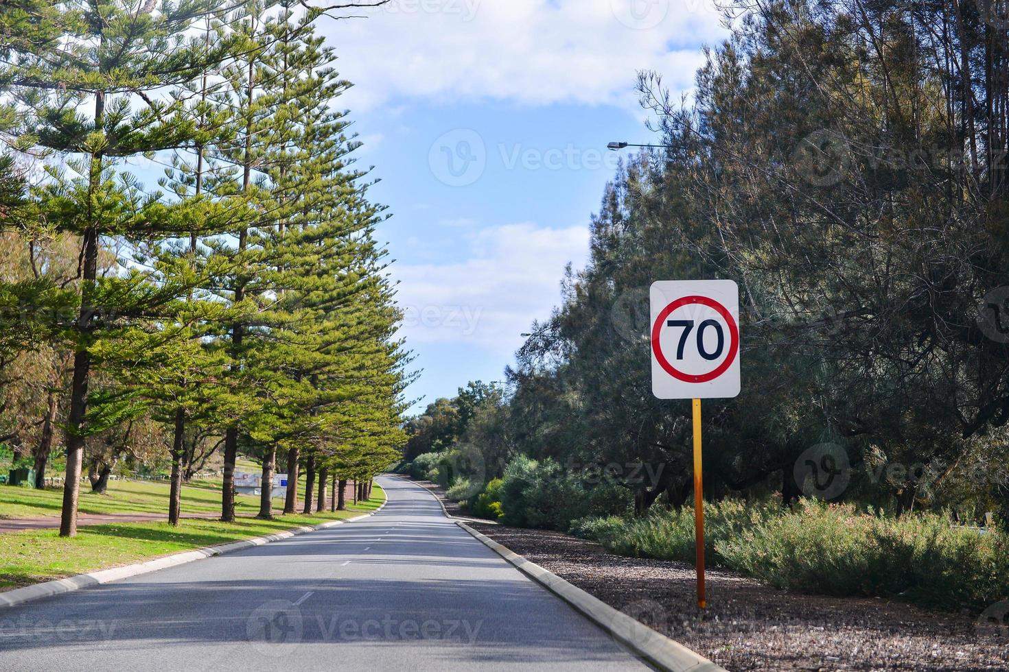 Speed 70 limit sign on a road photo