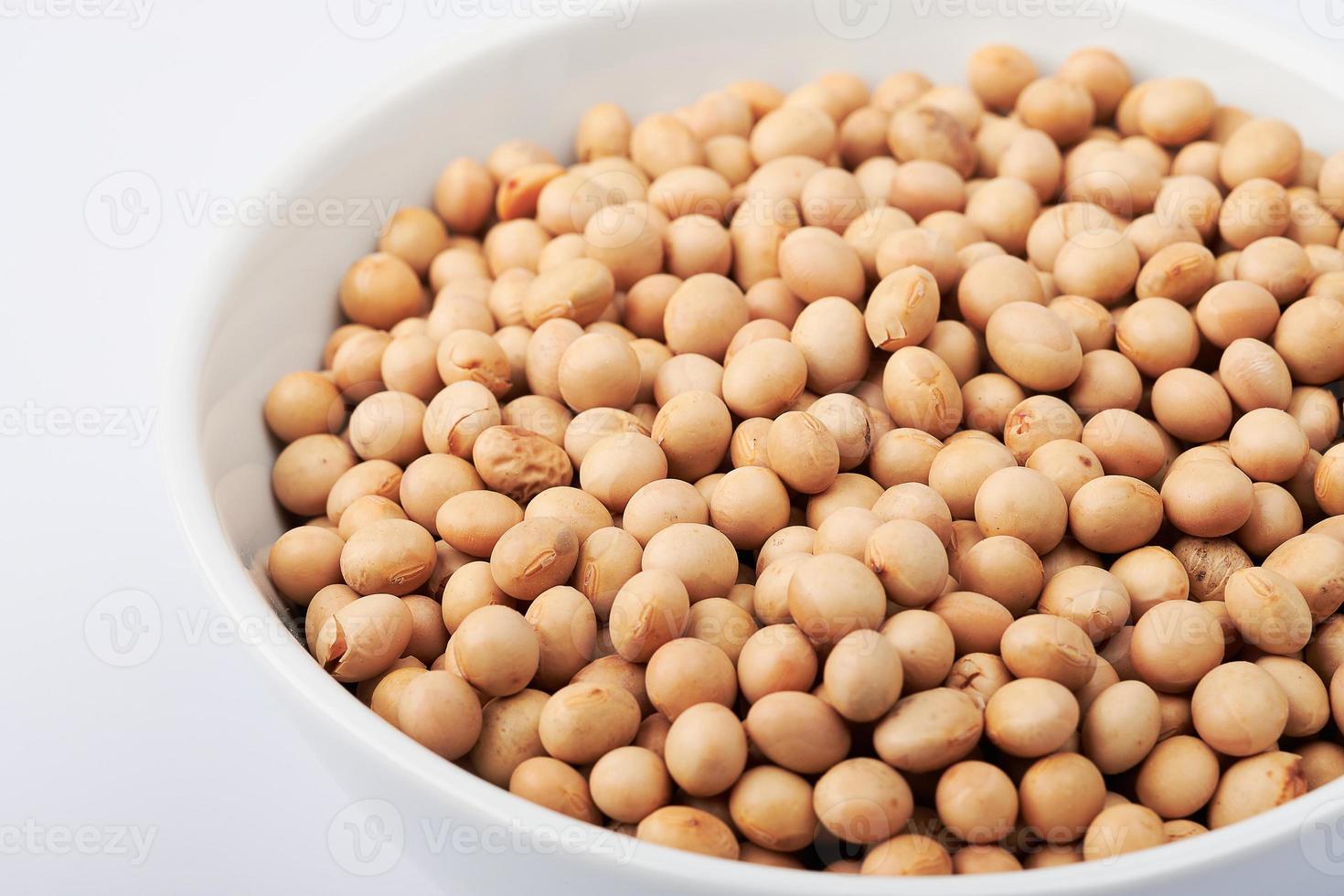 dried soybeans in white bowl background photo