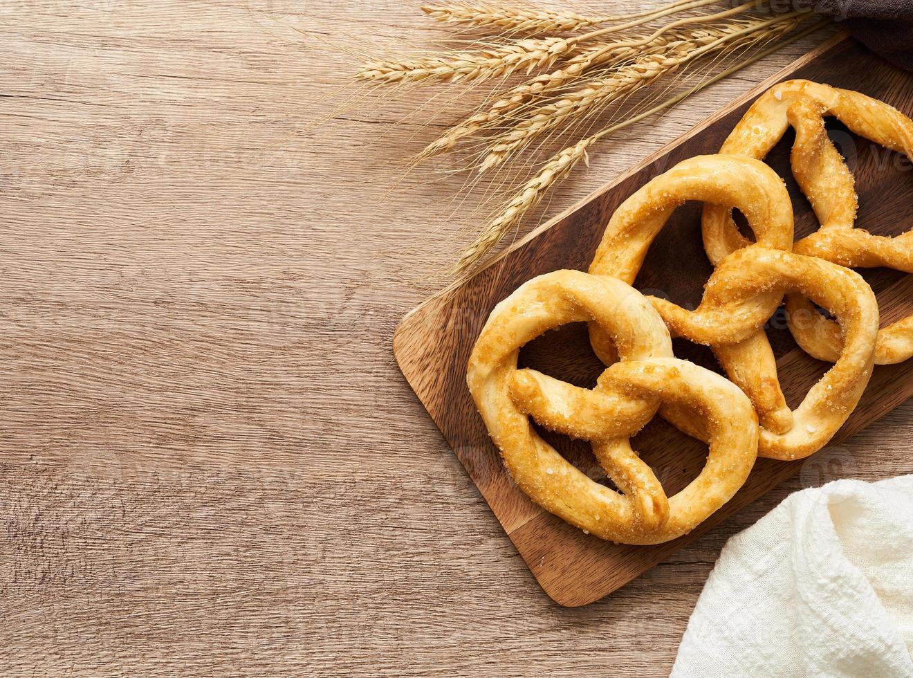 top view or flat lay group of pretzel in wood plate on wooden table background. photo