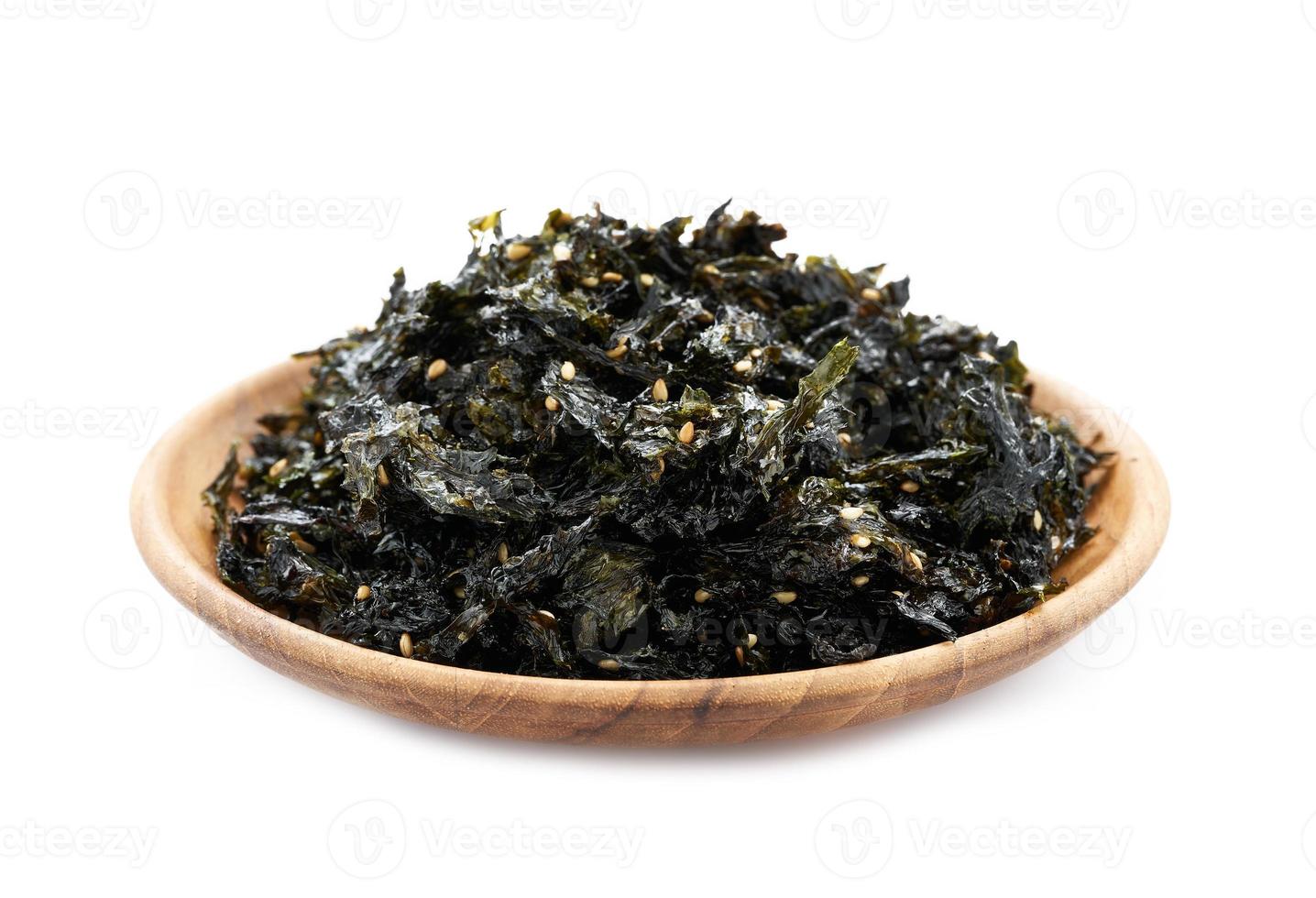 roasted nori seaweed and sesame topping in wood plate isolated on white background. nori laver seaweed crispy isolated on white background. Gim, laver, nori, isolated photo