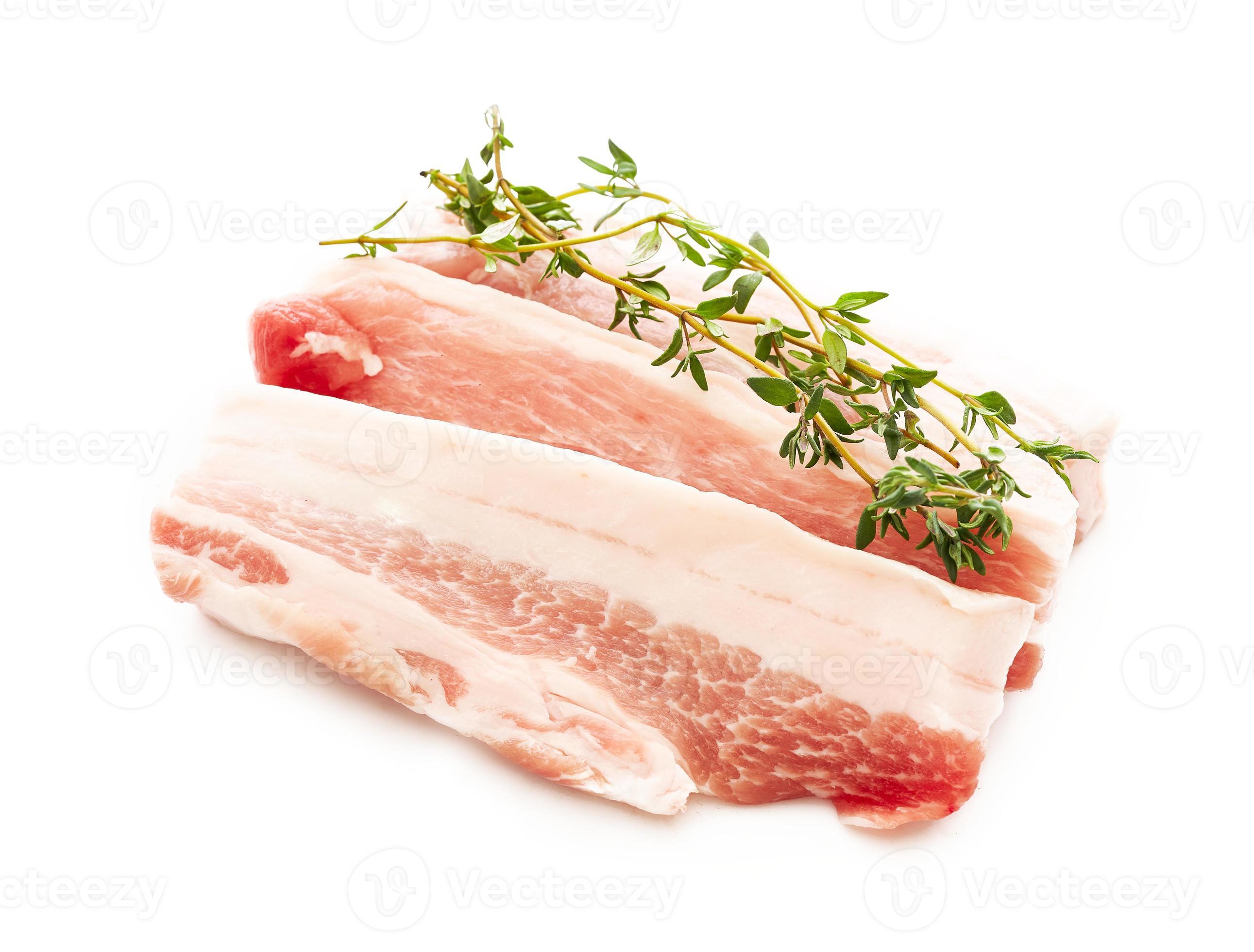 fresh raw streaky pork and thyme leaves isolated on white background