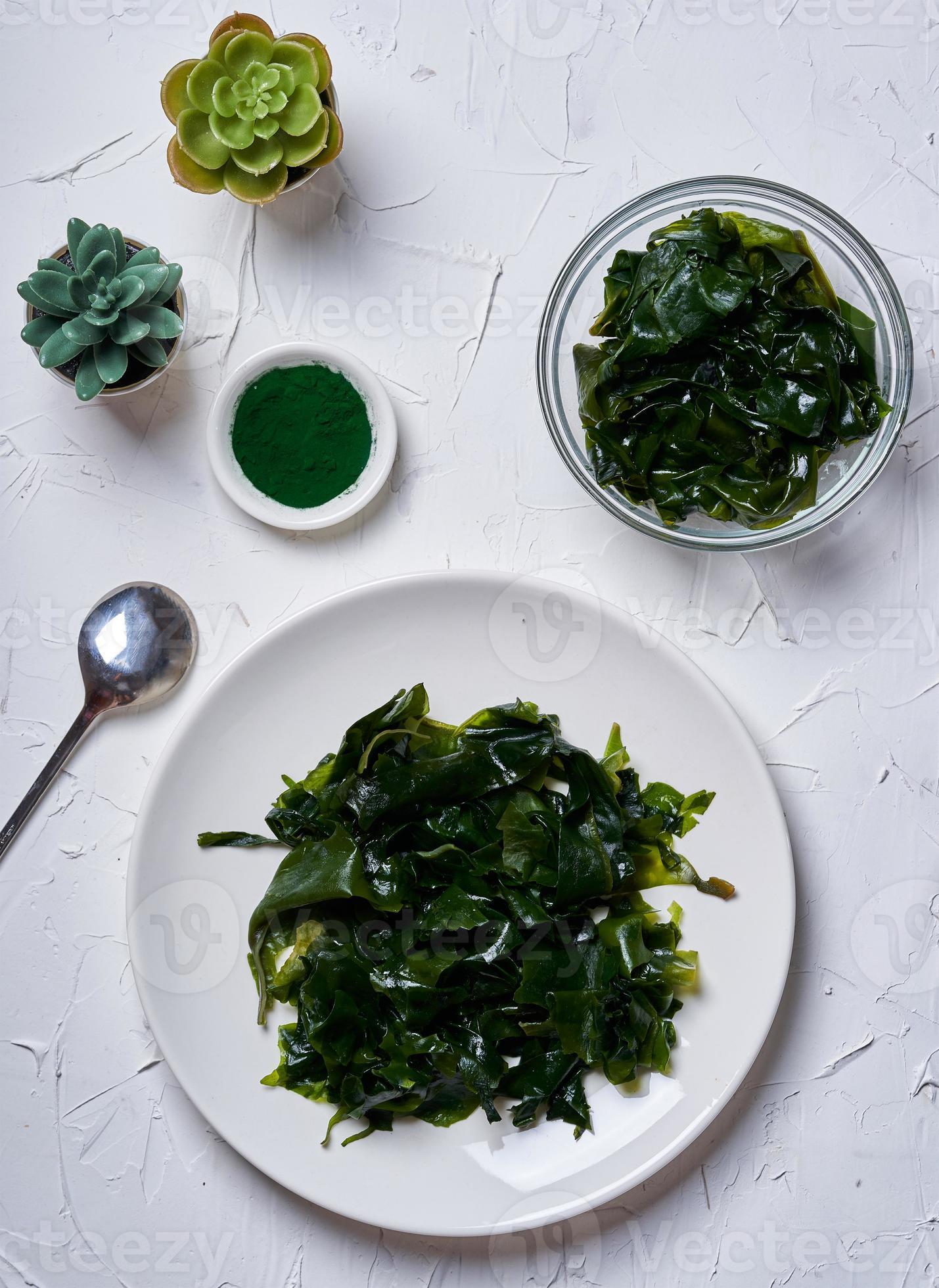 laminaria Kelp seaweed and spirulina powder with a ceramic bowl on