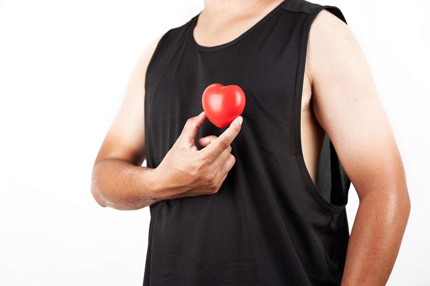 the concept Asian man who wears a black tank top shirt and two-tone skin arm holds a red heart isolated on white background photo