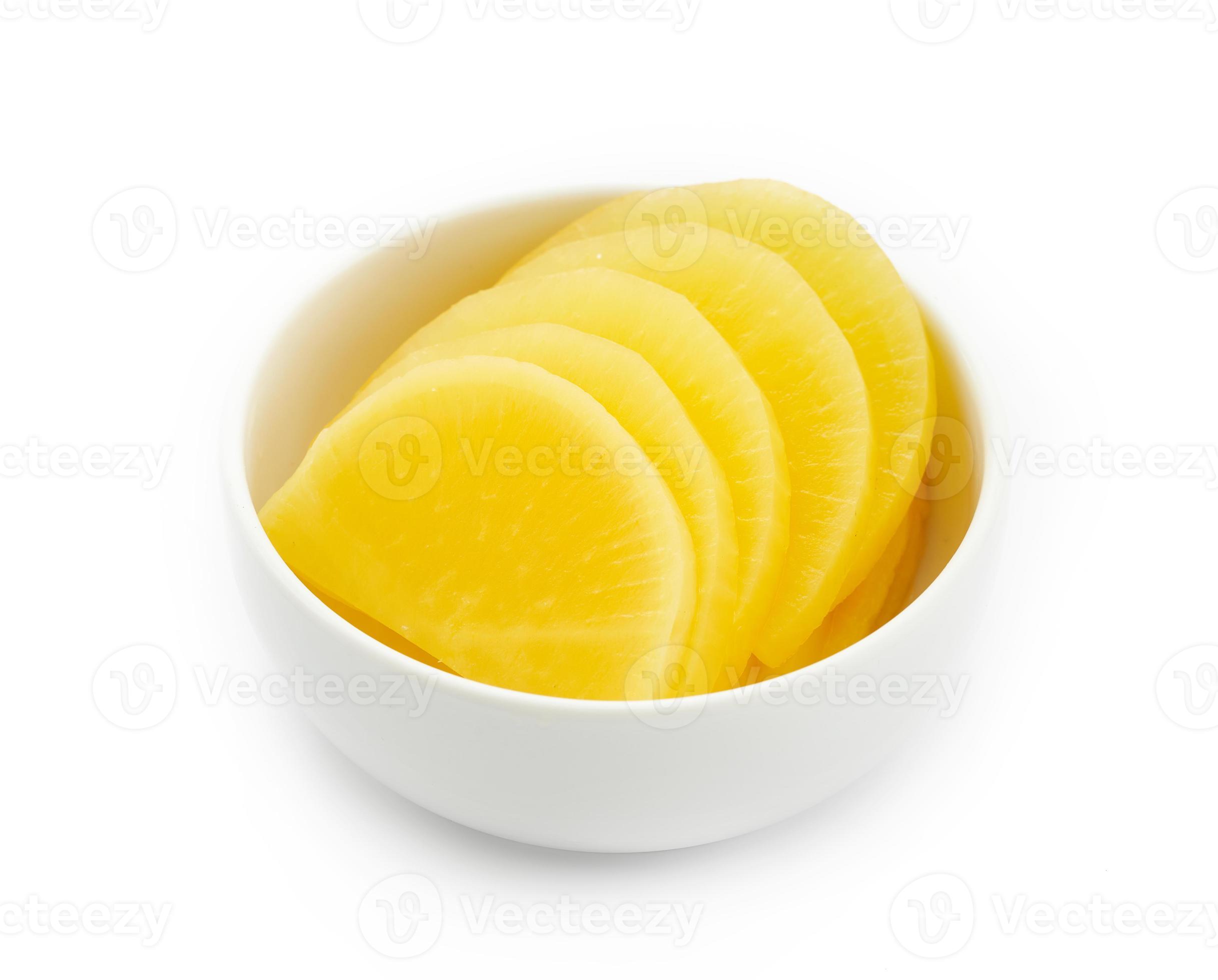Korean yellow pickled radish or Danmuji side dish in white bowl