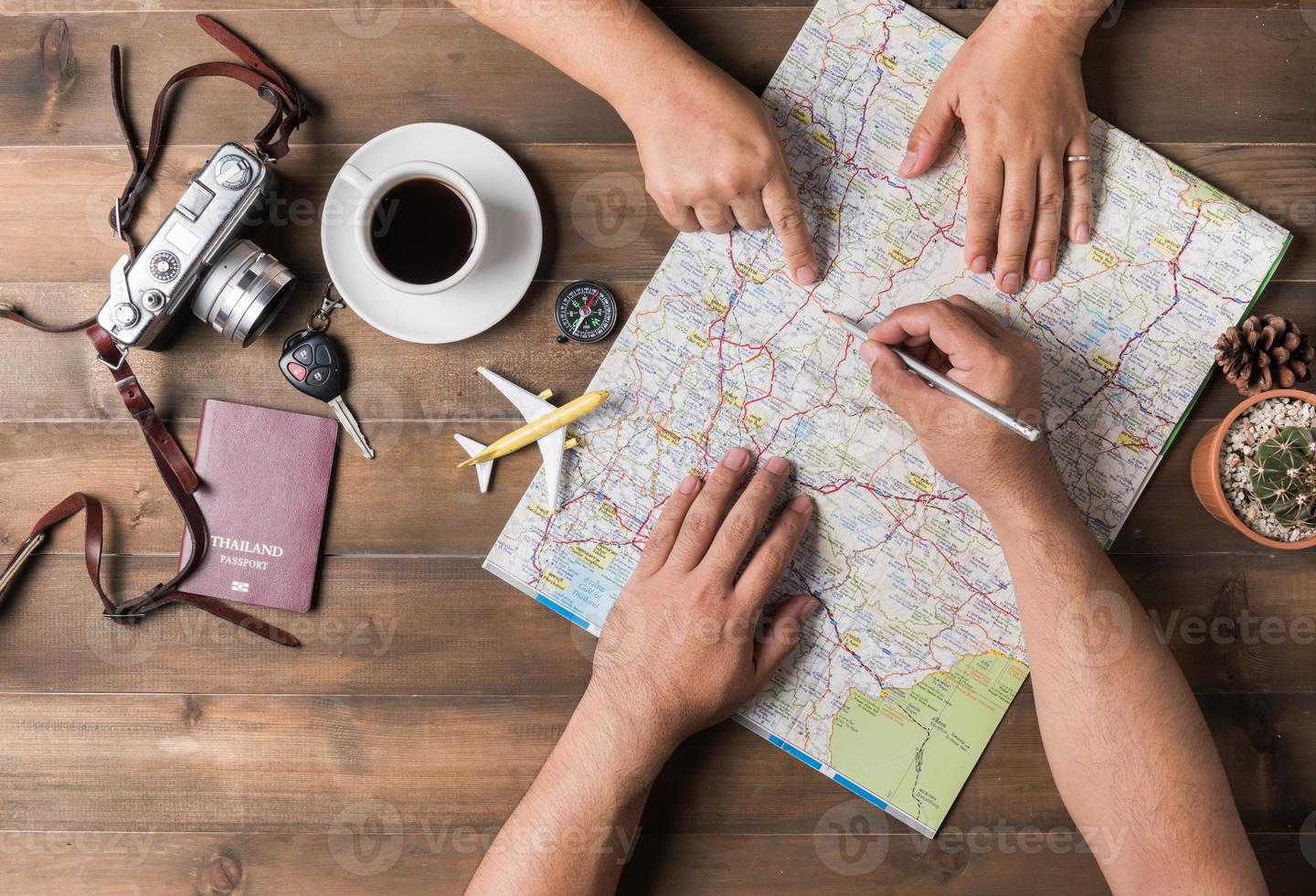 Young couple planning  vacation trip with map. Top view. photo