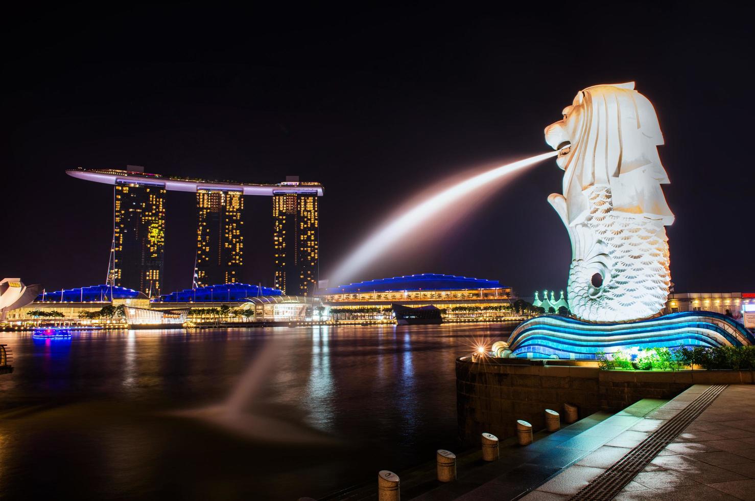 SINGAPORE-SEP 04-The Merlion fountain and Marina Bay Sand on Sep. 04, 2014. Merlion is an imaginary creature with a head of a lion and the body of a fish and  symbol of Singapore. photo