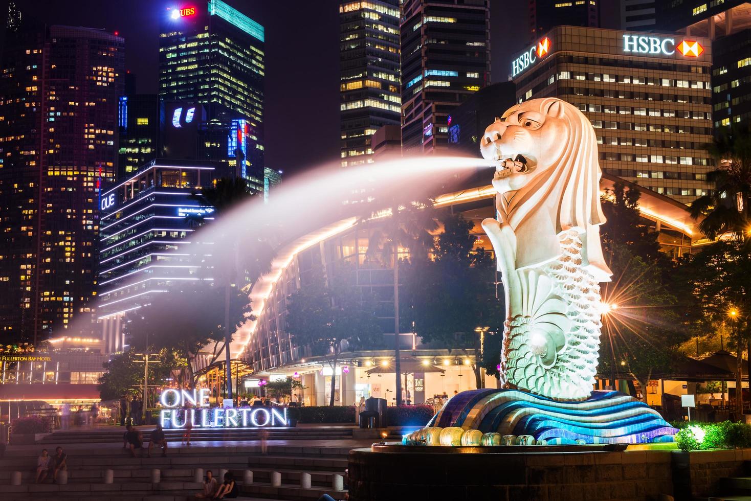 SINGAPORE-SEP 04-The Merlion fountain and downtown on Sep. 04, 2014. Merlion is an imaginary creature with a head of a lion and the body of a fish and  symbol of Singapore. photo