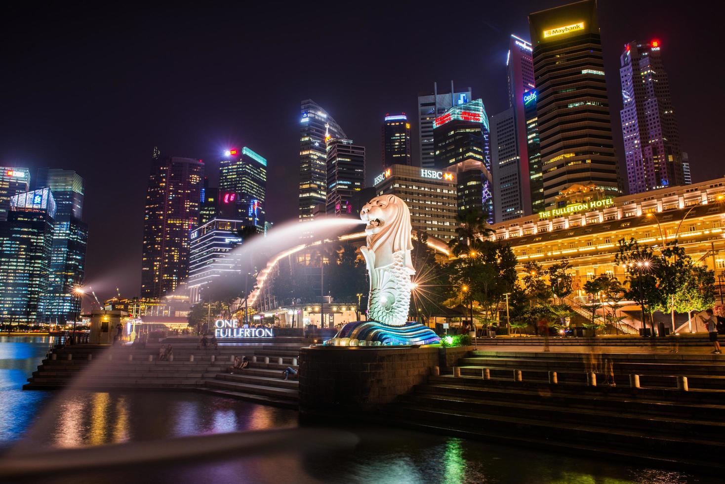 SINGAPORE-SEP 04-The Merlion fountain and downtown on Sep. 04, 2014. Merlion is an imaginary creature with a head of a lion and the body of a fish and  symbol of Singapore. photo