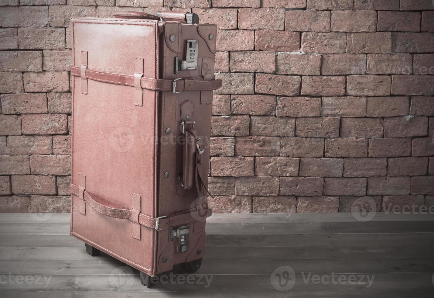 leather retro baggage on brick background photo