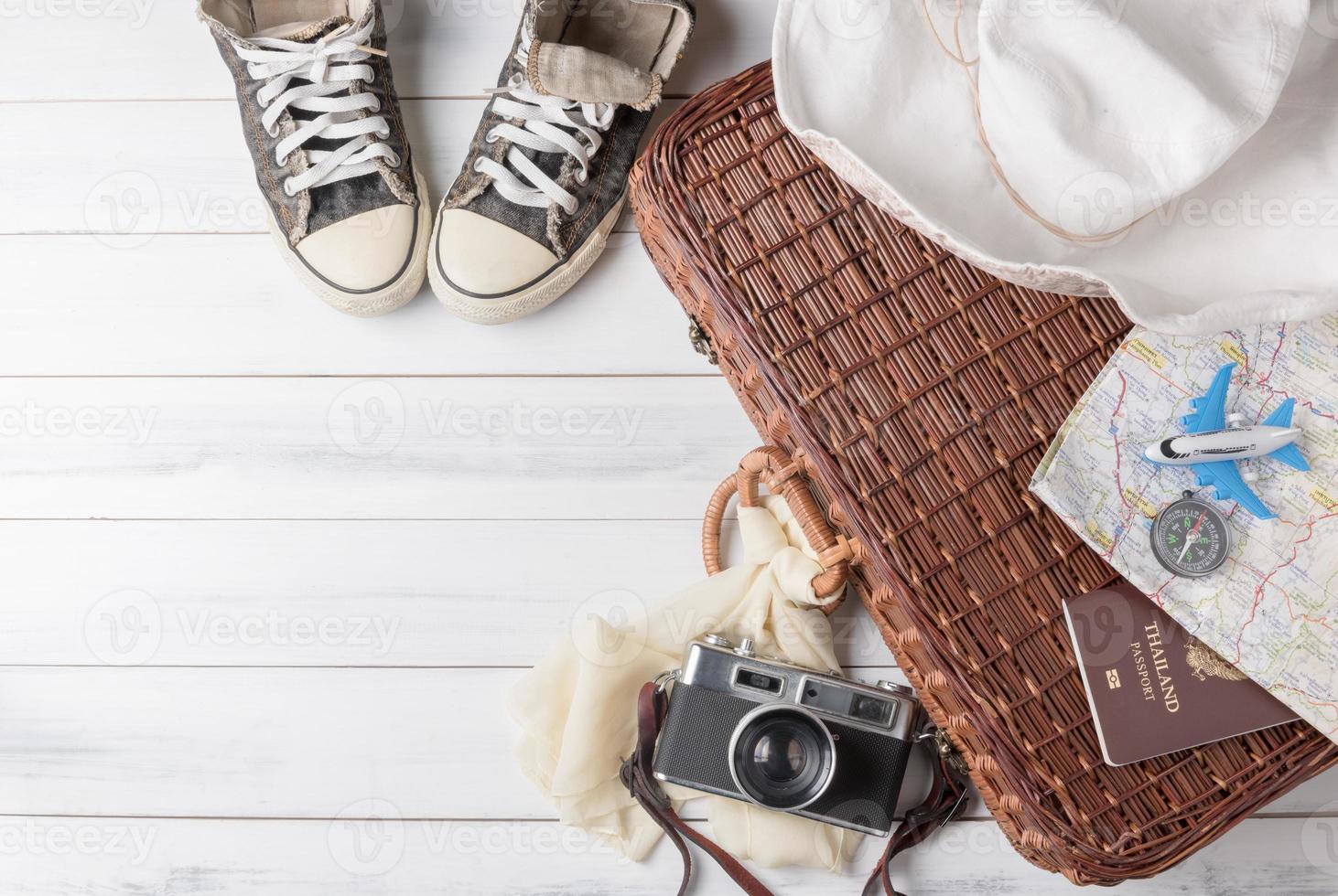 Travel accessories costumes. Passports, luggage, vintage camera, wicker bag, sneake. photo