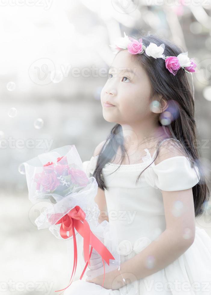 little bride holding the rose bouquet, vintage tone photo