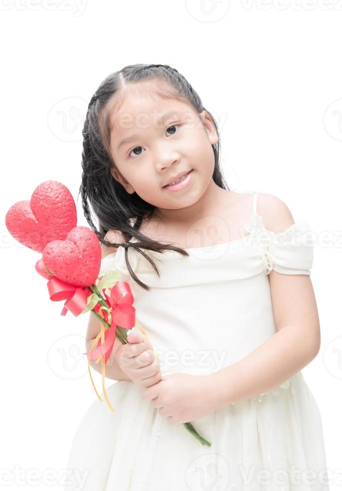 Cute asian little bridesmaid holding heart flower isolated. photo