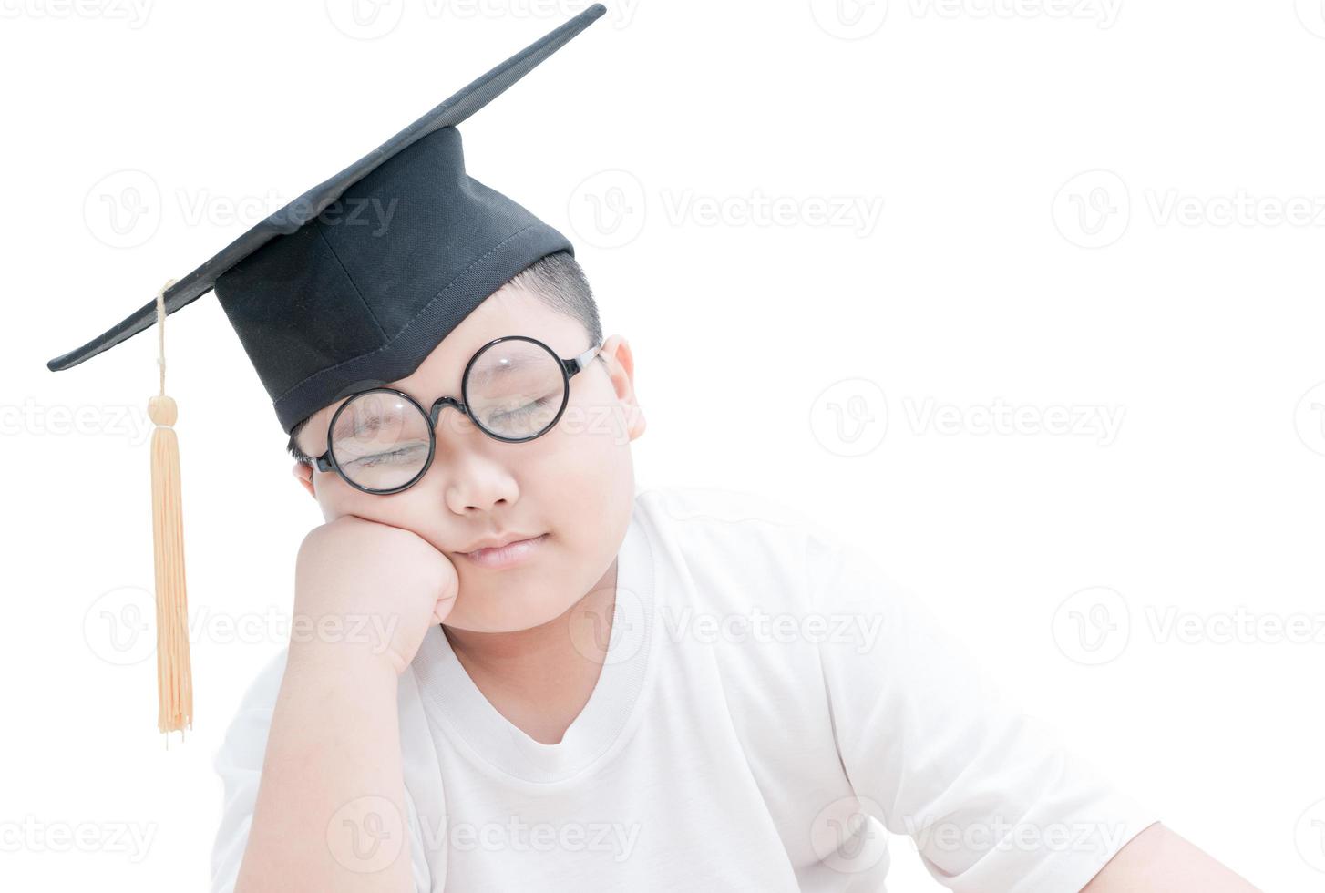 Asian school kid graduate sleep with graduation cap isolated photo