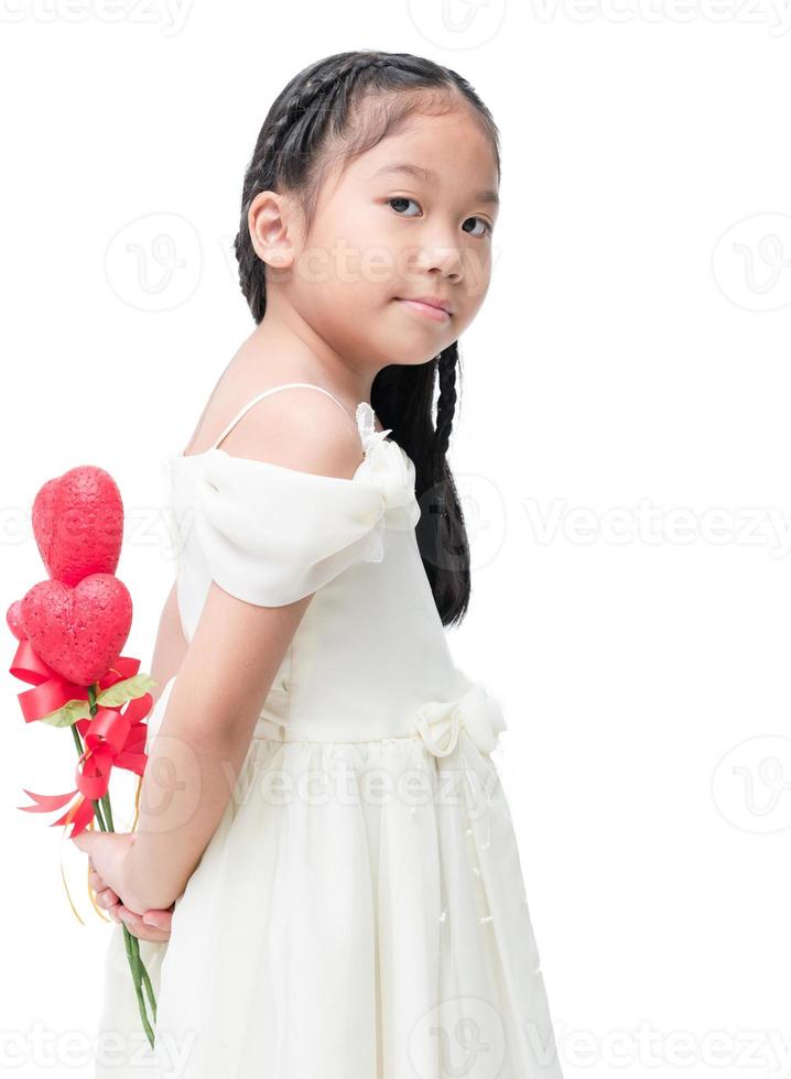 Cute asian little bridesmaid holding heart flower isolated photo