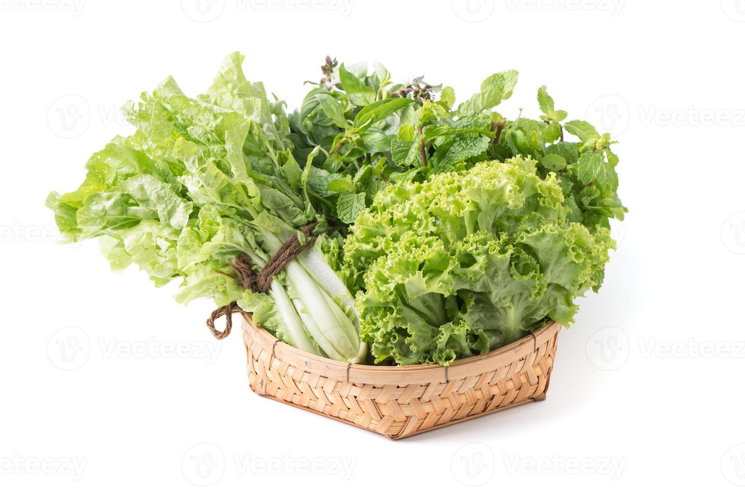 peppermint, sweet basil, lettuce in bamboo basket isolated photo