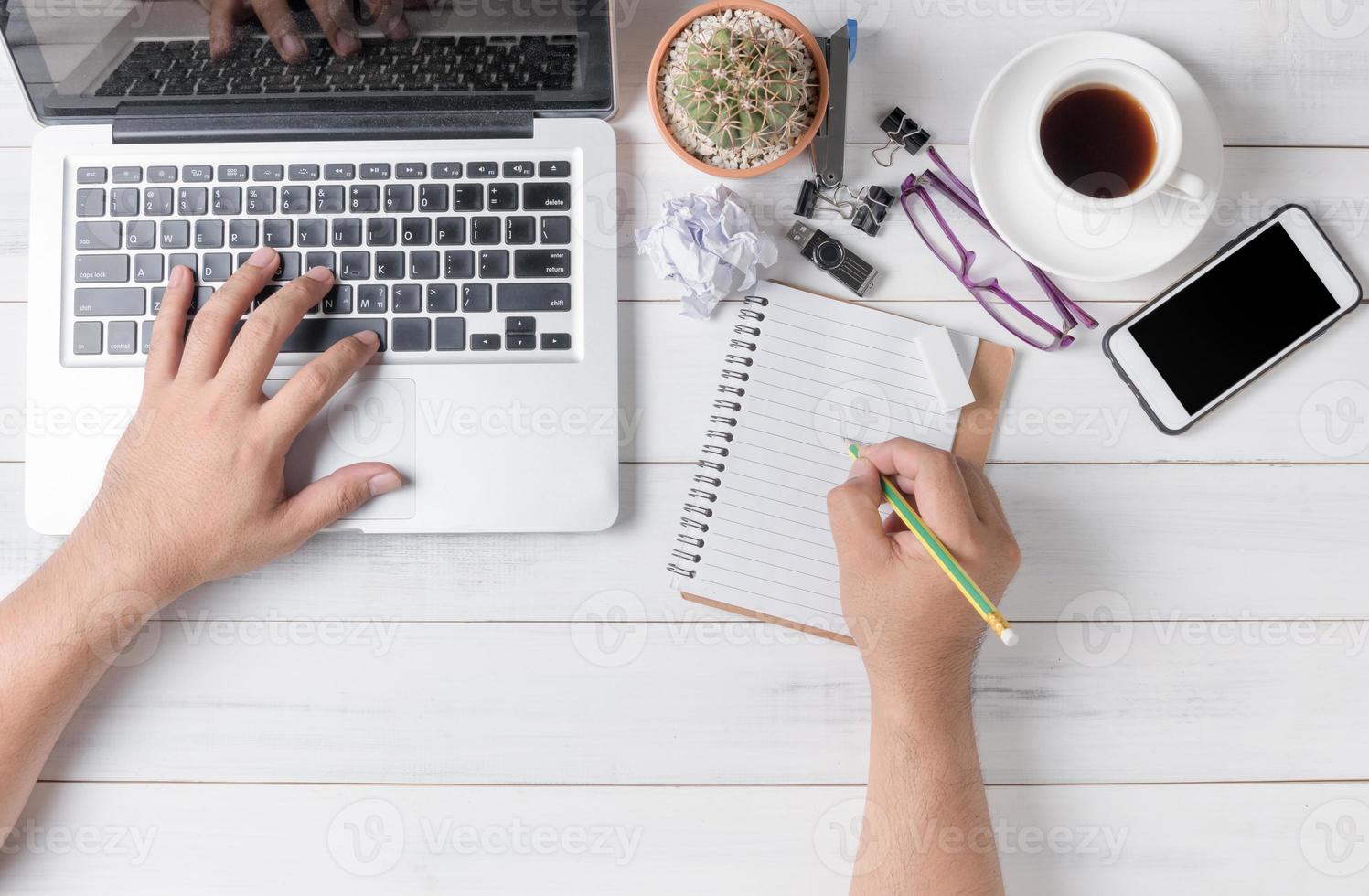 business hand man using computer and writing on blank notebook photo