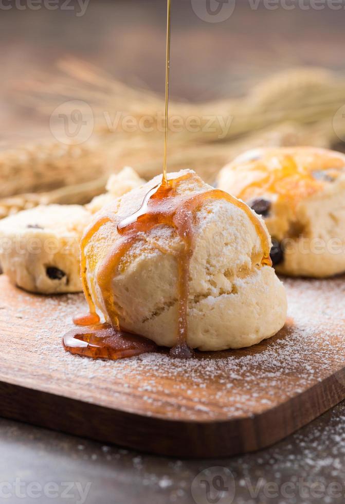 scones and honey on top on wood background photo