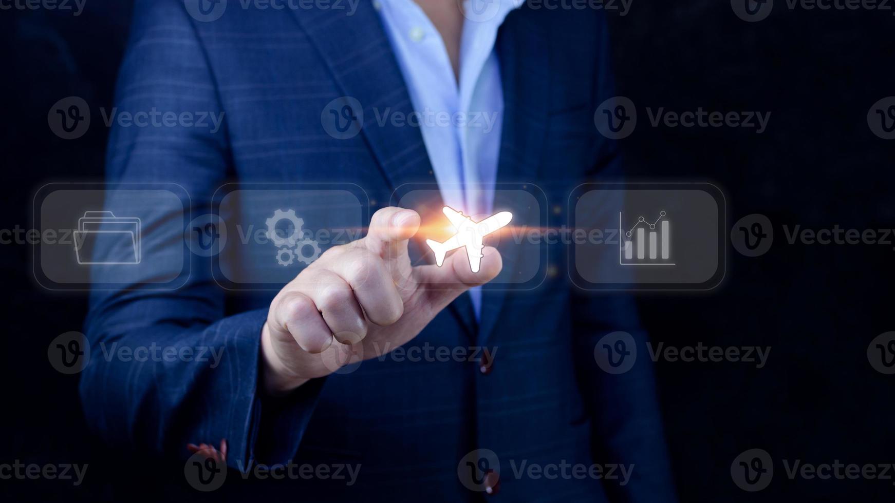Businessman pointing finger touching to select flight by pressing touch screen airplane button,Business Airplane transportation concept photo