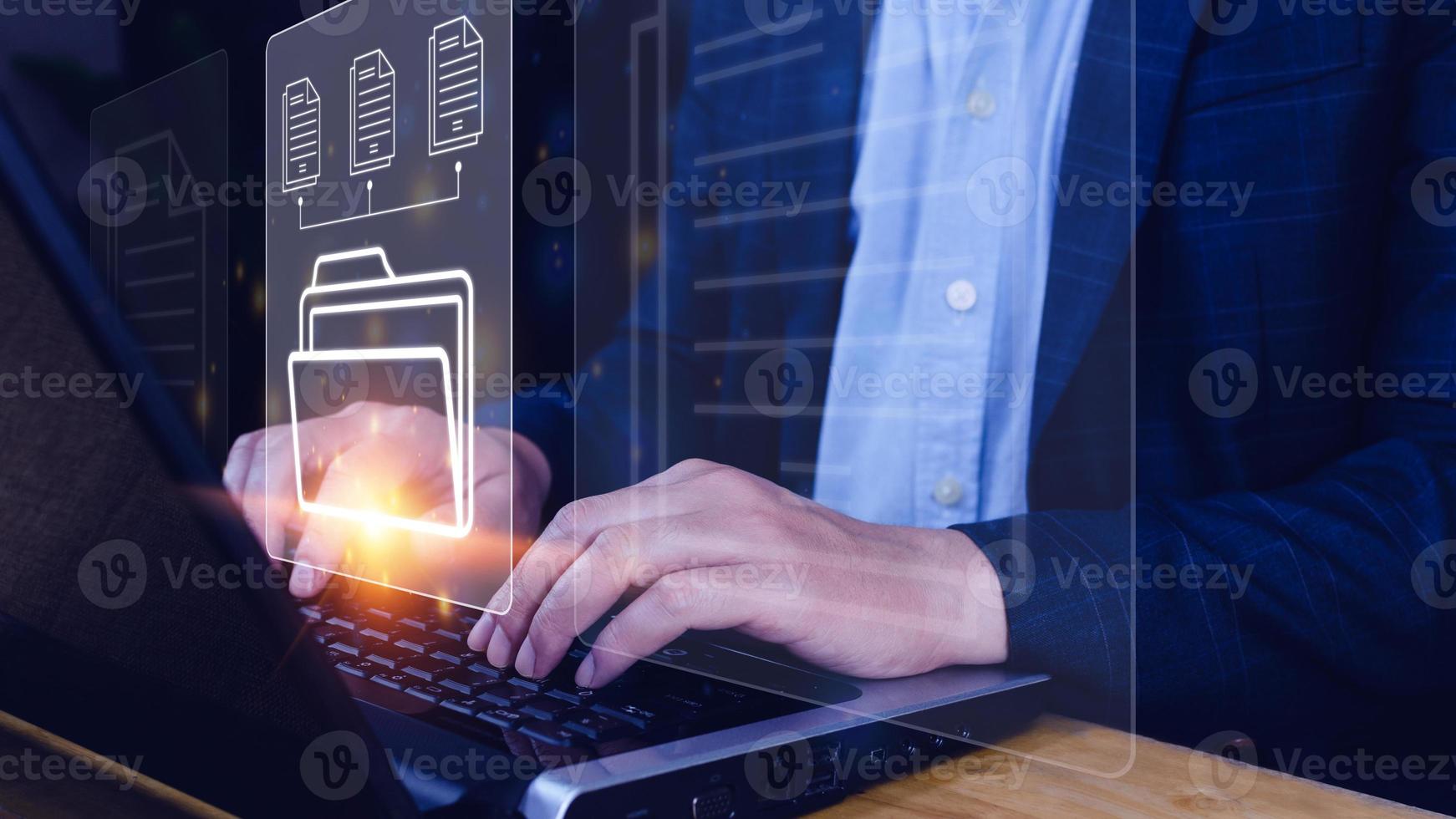 Document Management System DMS being setup IT consultant working on laptop computer in office. Software for archiving, searching and managing corporate files information photo