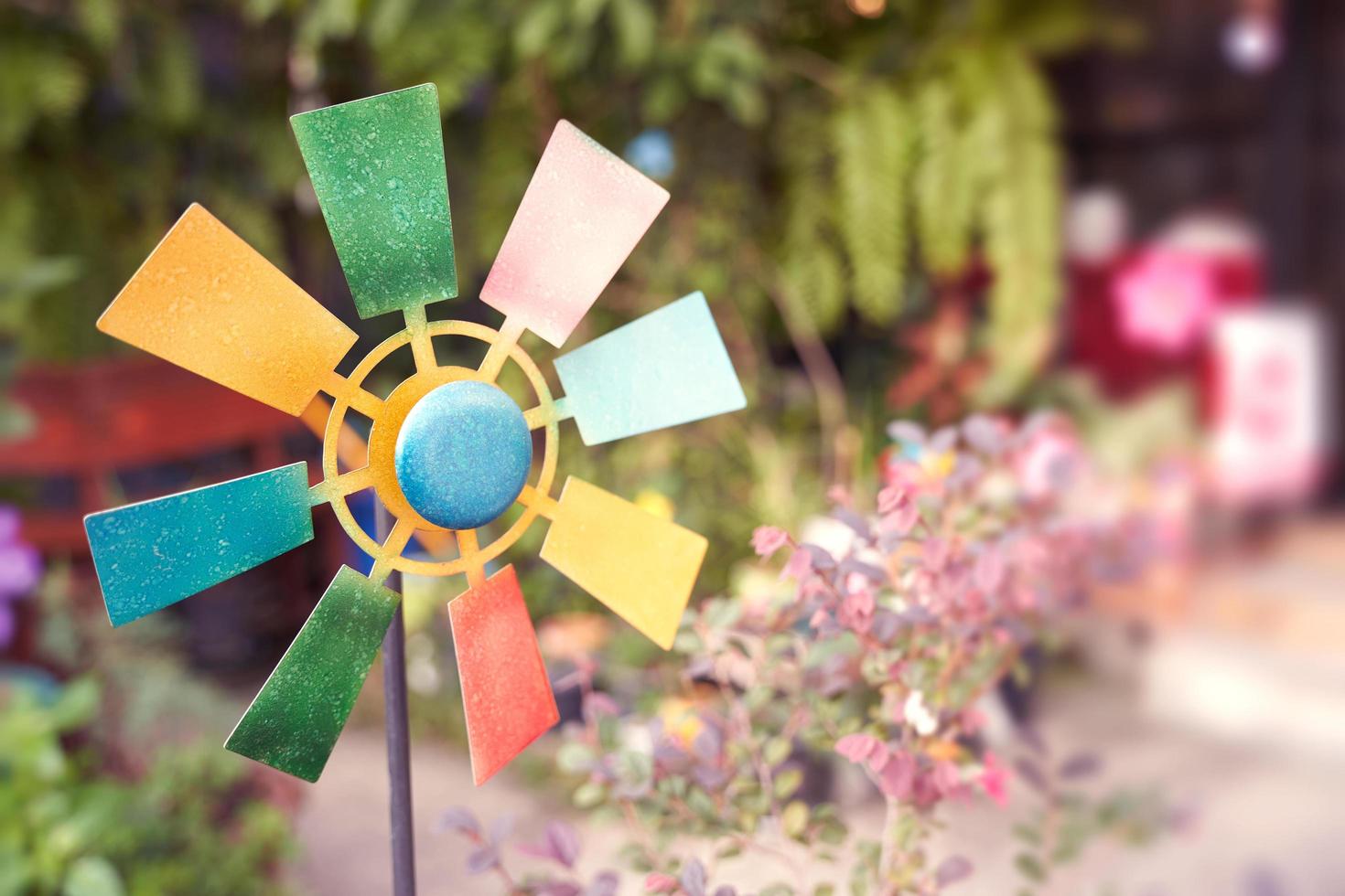 colorful windmill toy on nature blur background photo
