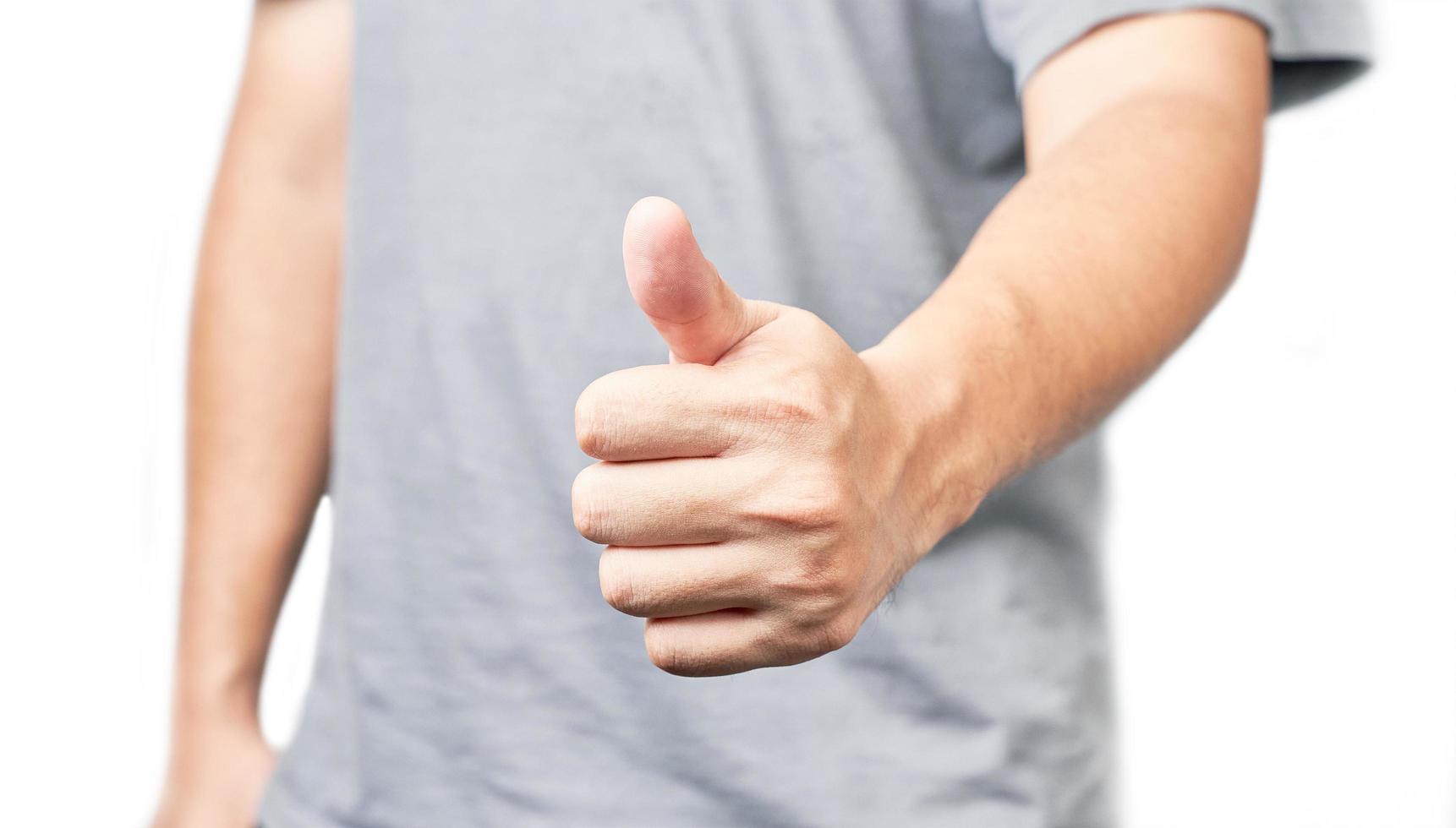 Asian man showing thumbs up closeup shot isolated on white background photo