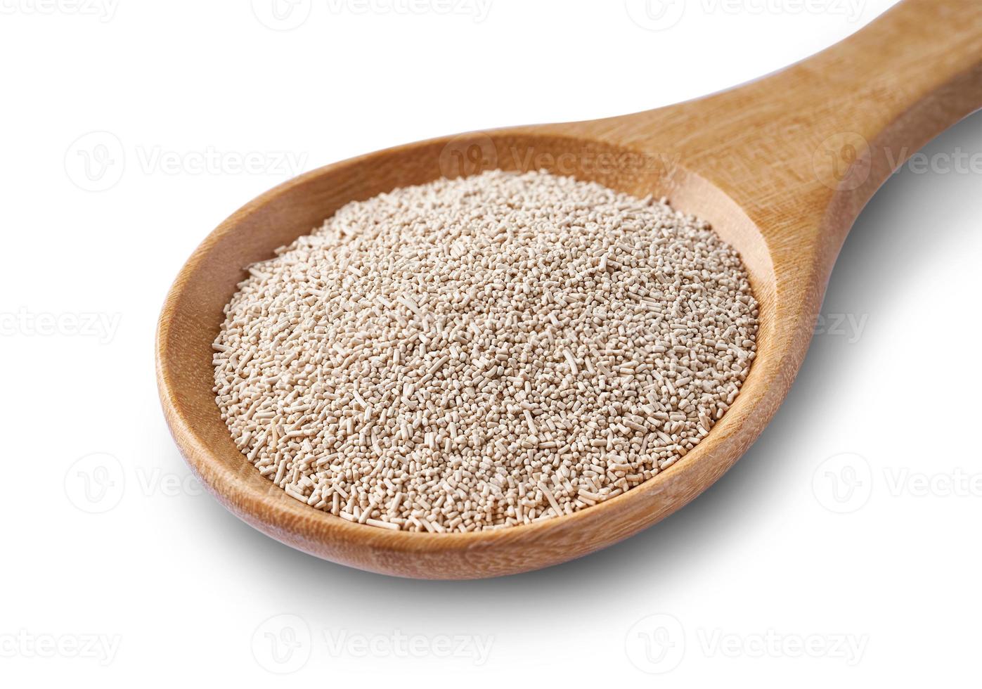 instant dry yeast in wooden spoon isolated on white background with clipping path photo