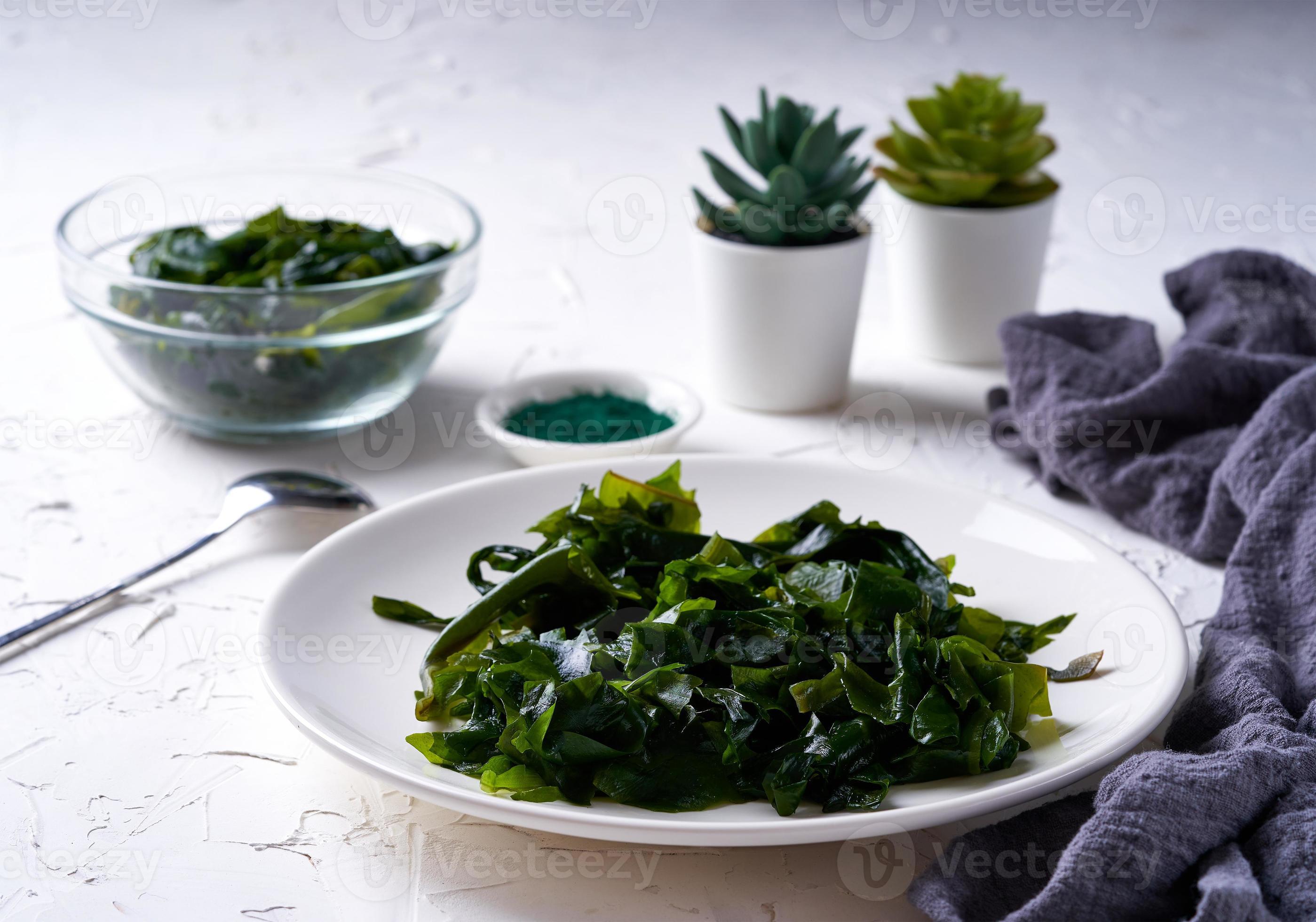 laminaria Kelp seaweed and spirulina powder with a ceramic bowl on