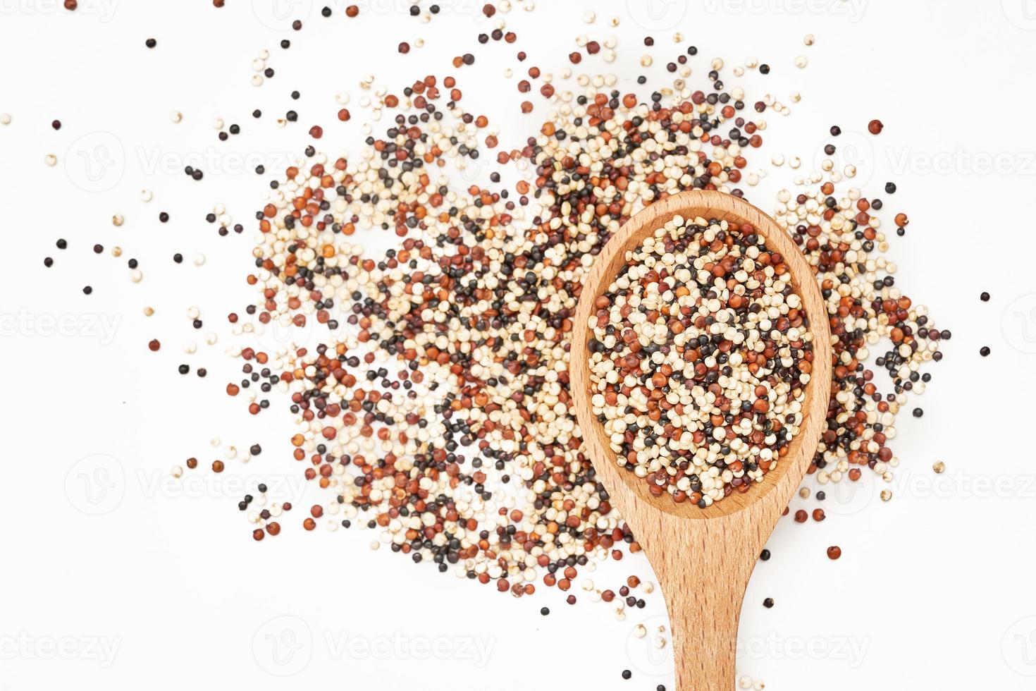 top view or flat lay quinoa seeds in wooden spoon isolated on white background. close up quinoa seeds in wooden spoon isolated on white background. quinoa seeds in spoon isolated photo