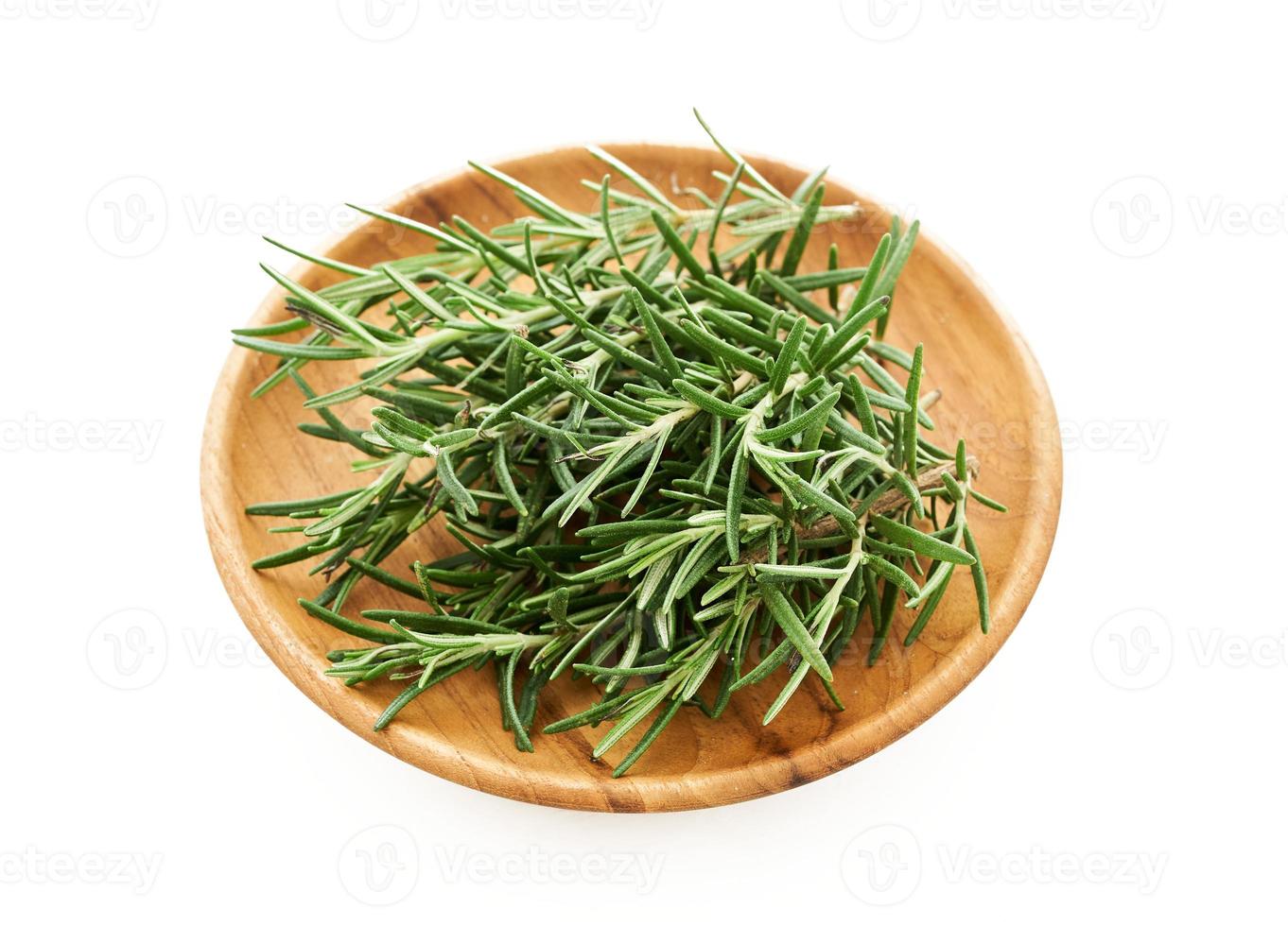 rosemary in wood bowl isolated on white background. spice rosemary isolated on white background. rosemary photo