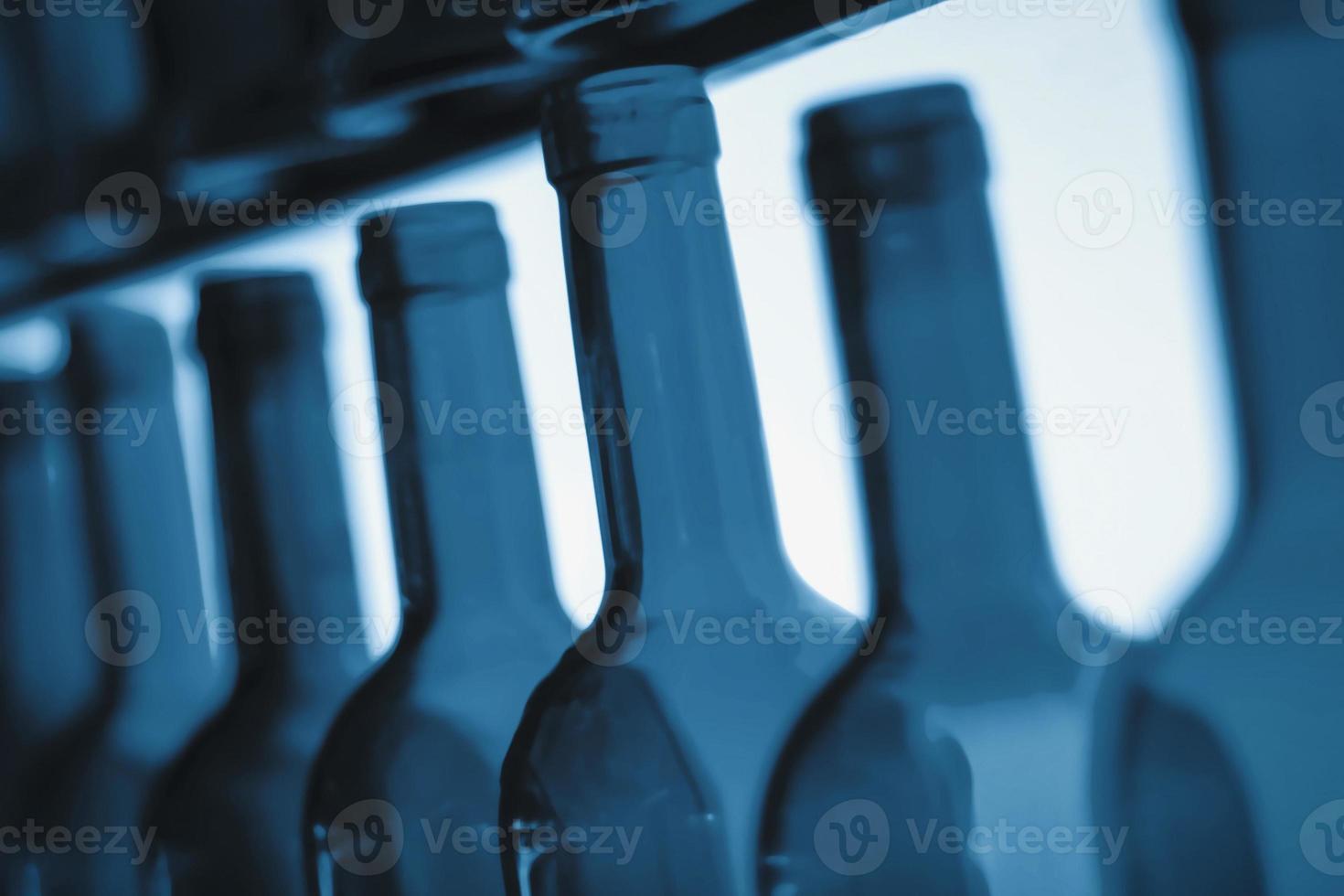 empty wine bottle necks in a row as illustration of binge or problem drinking and depression caused by alcohol addiction photo