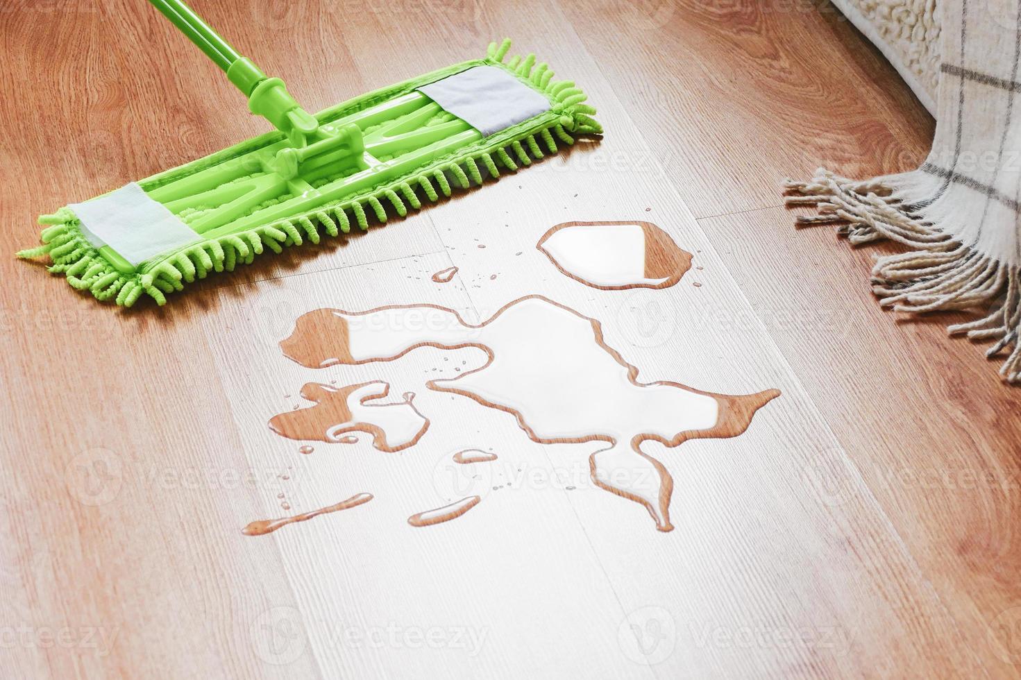 Wiping water on the floor in the bedroom with a mop photo