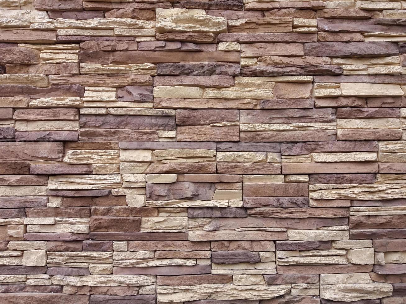 beige brown artificial stone wall texture photo