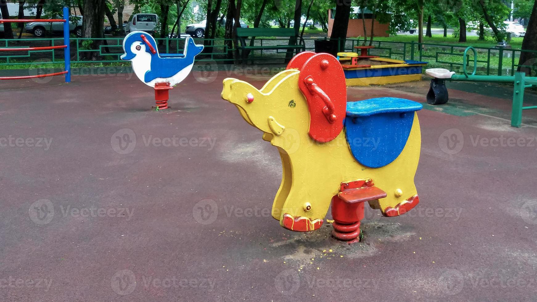 play ground in summer park, empty swing and rocking horse photo