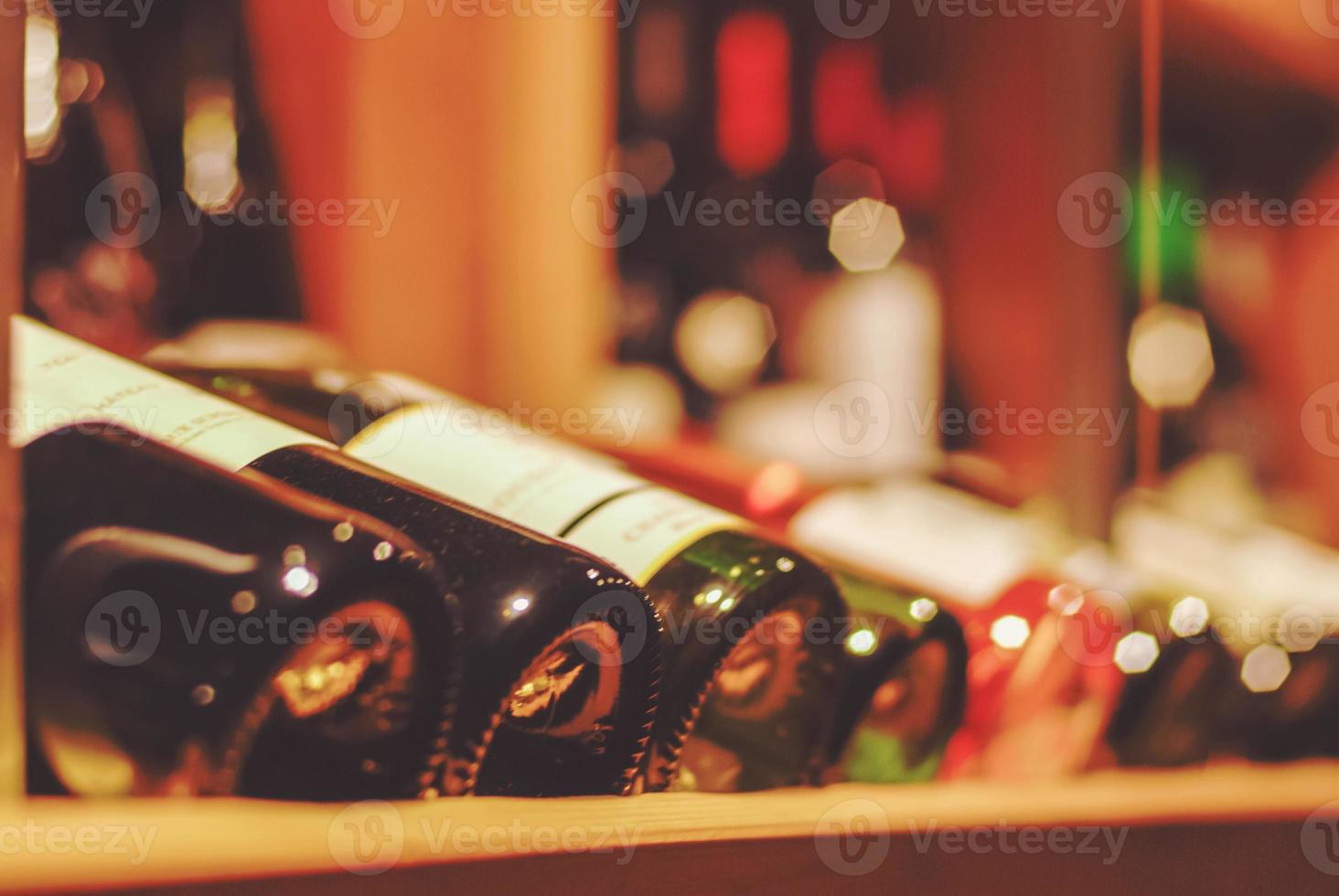 bottles of wine on the shelves of wine bar and wine shop photo