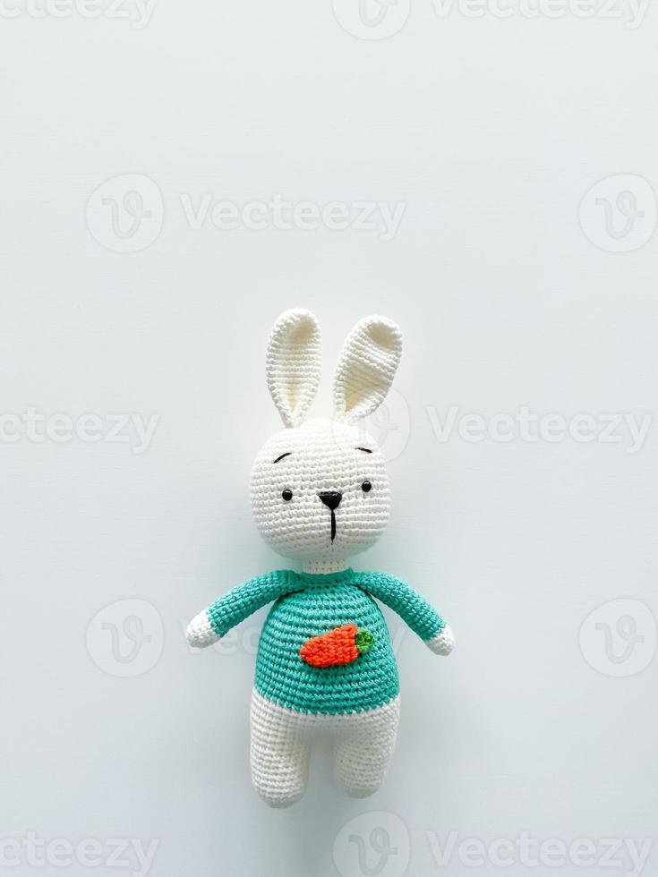 Soft white crochet bunny. on a white background. photo