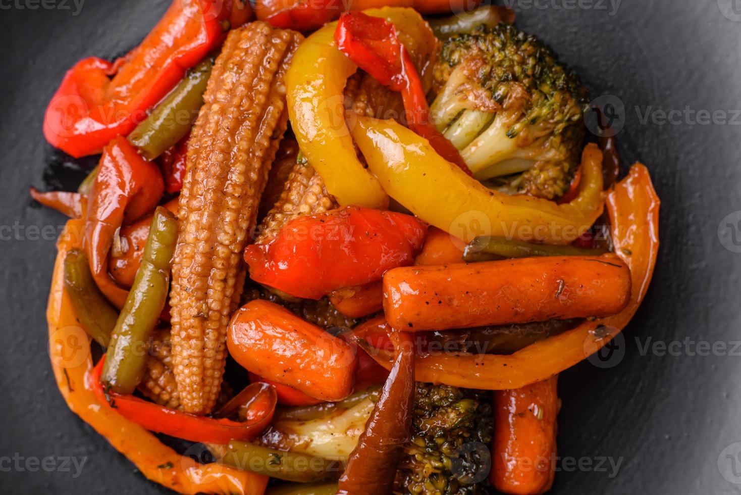 Mix of vegetables corn, carrots, peppers, broccoli, onions in teriyaki sauce photo