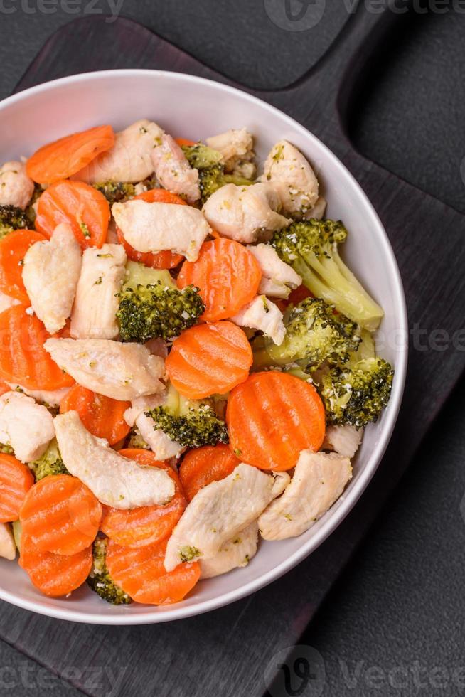 Delicious dish consisting of pieces of boiled chicken, broccoli and carrots photo