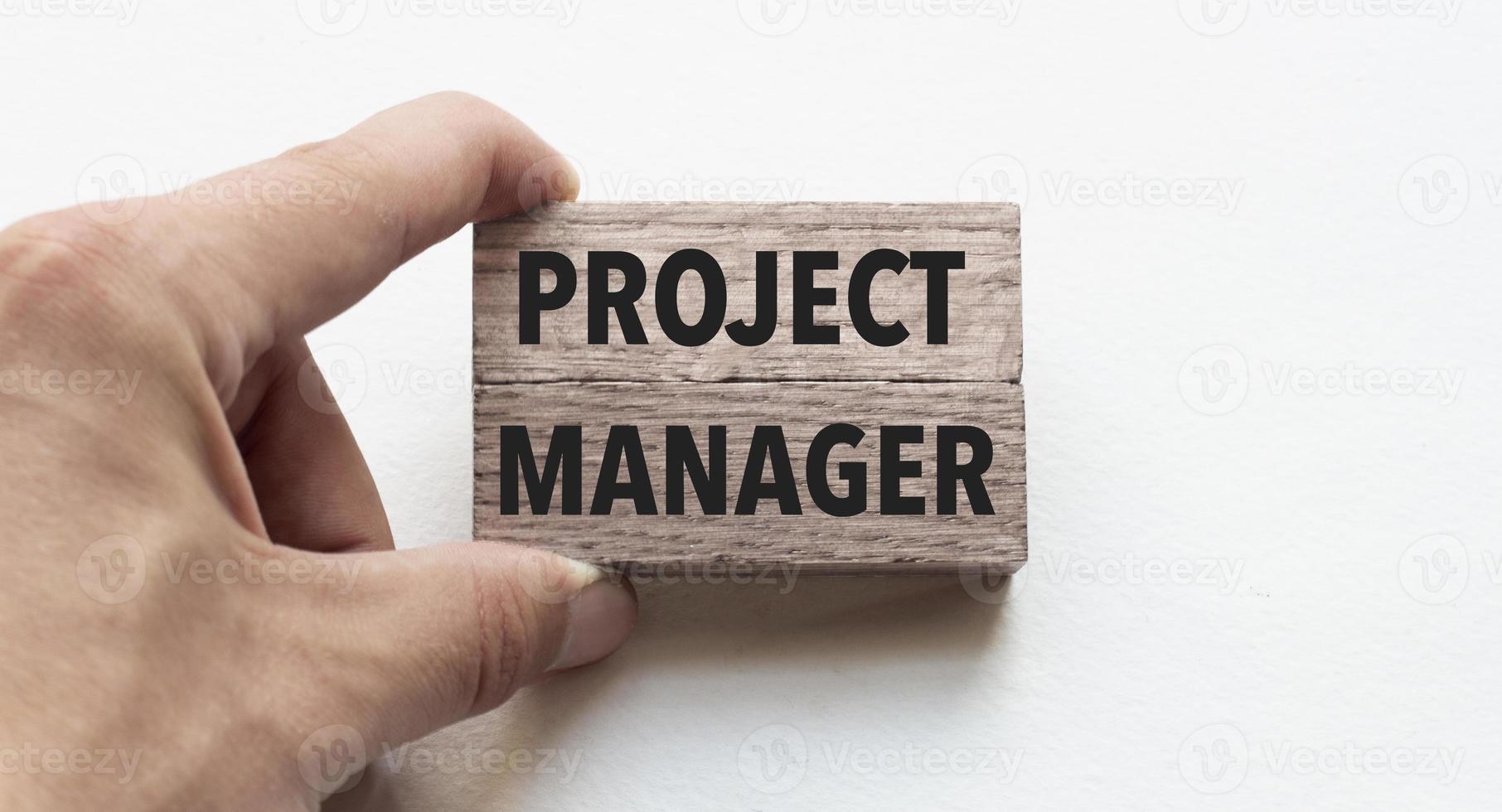 Hand of a businessman holding wooden blocks. Conceptual image. Text project management concept business succeed. photo