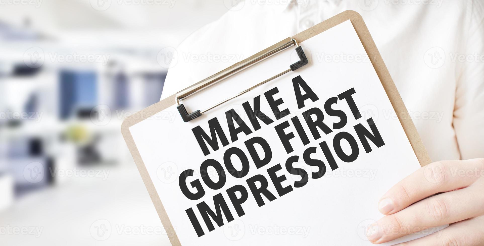 Businessman hold white card with text Make a good first impression Calculator, wood box, money and financial documents photo