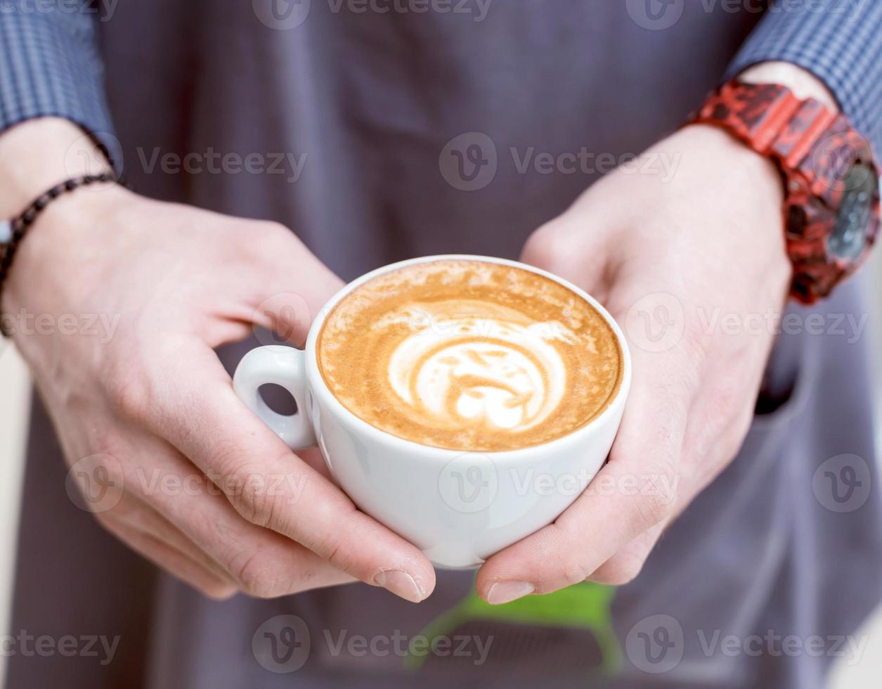 Barista holding coffee photo